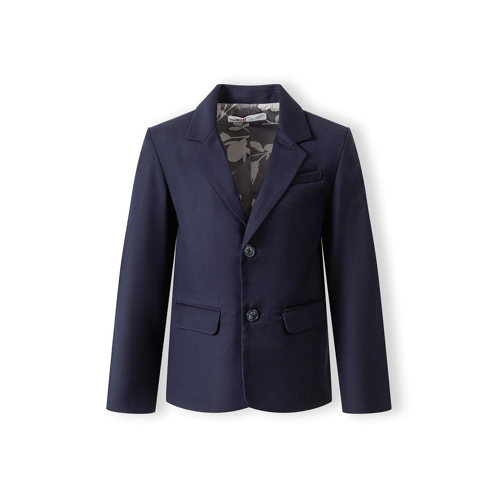 Close-up detail of navy blazer showing chest pocket construction and premium fabric texture