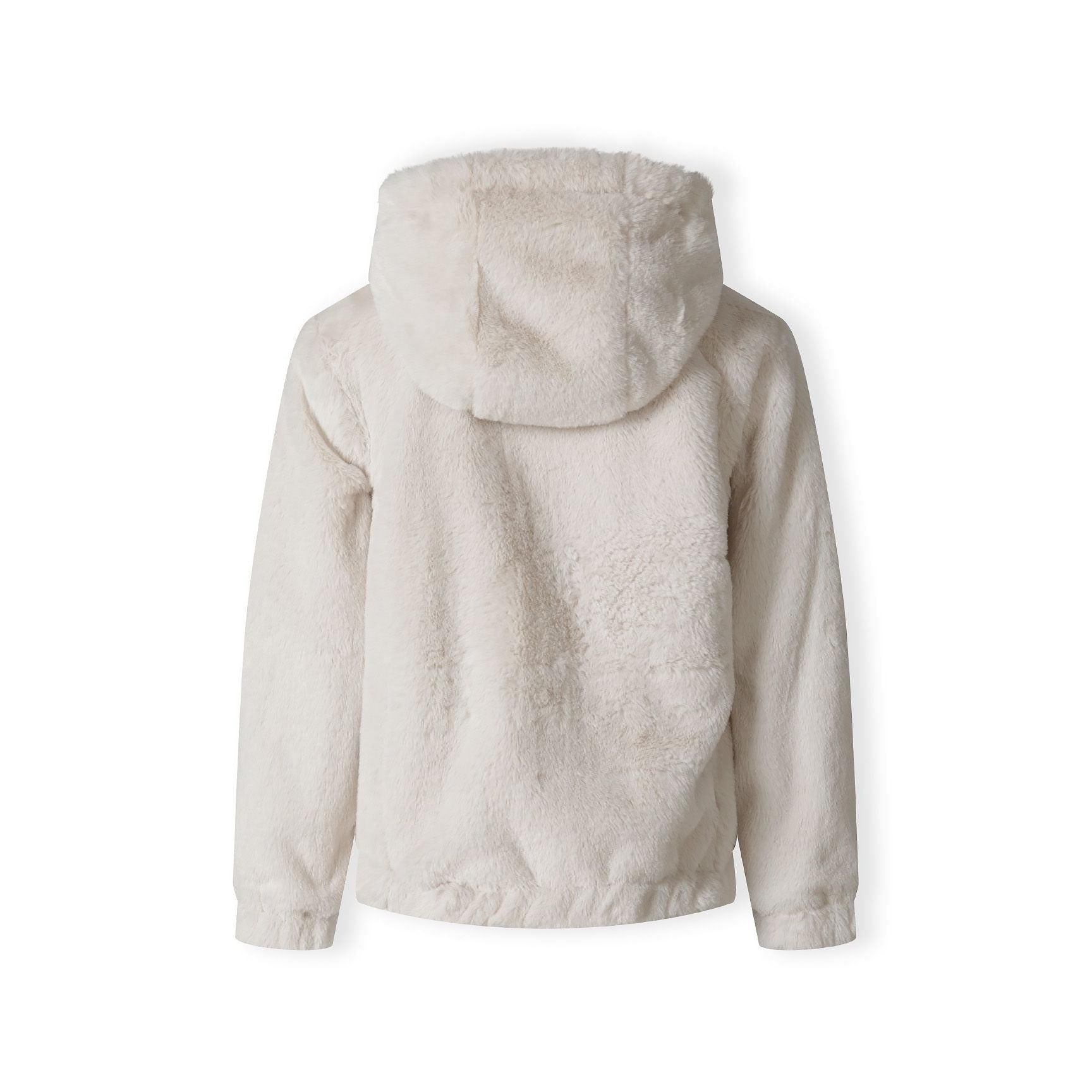 Close-up of cream teddy fur fabric texture showing soft fluffy pile and plush finish of jacket interior