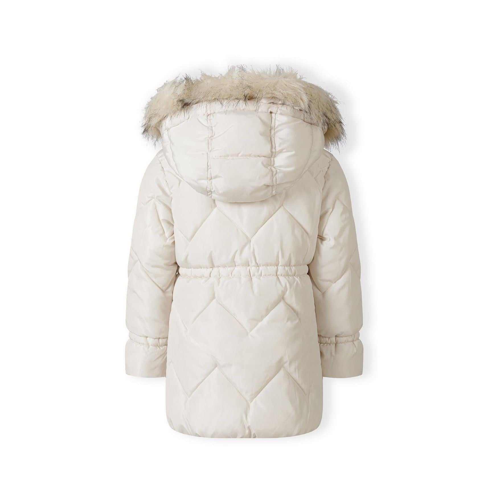 Close-up detail of cream quilted parka jacket showing diamond quilting pattern, faux fur hood trim texture and snap button closure on white background