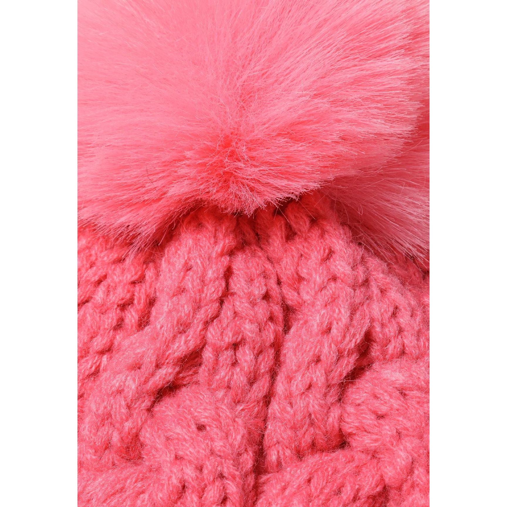 Close-up detail of pink cable knit texture and fluffy pom pom attachment on hat crown
