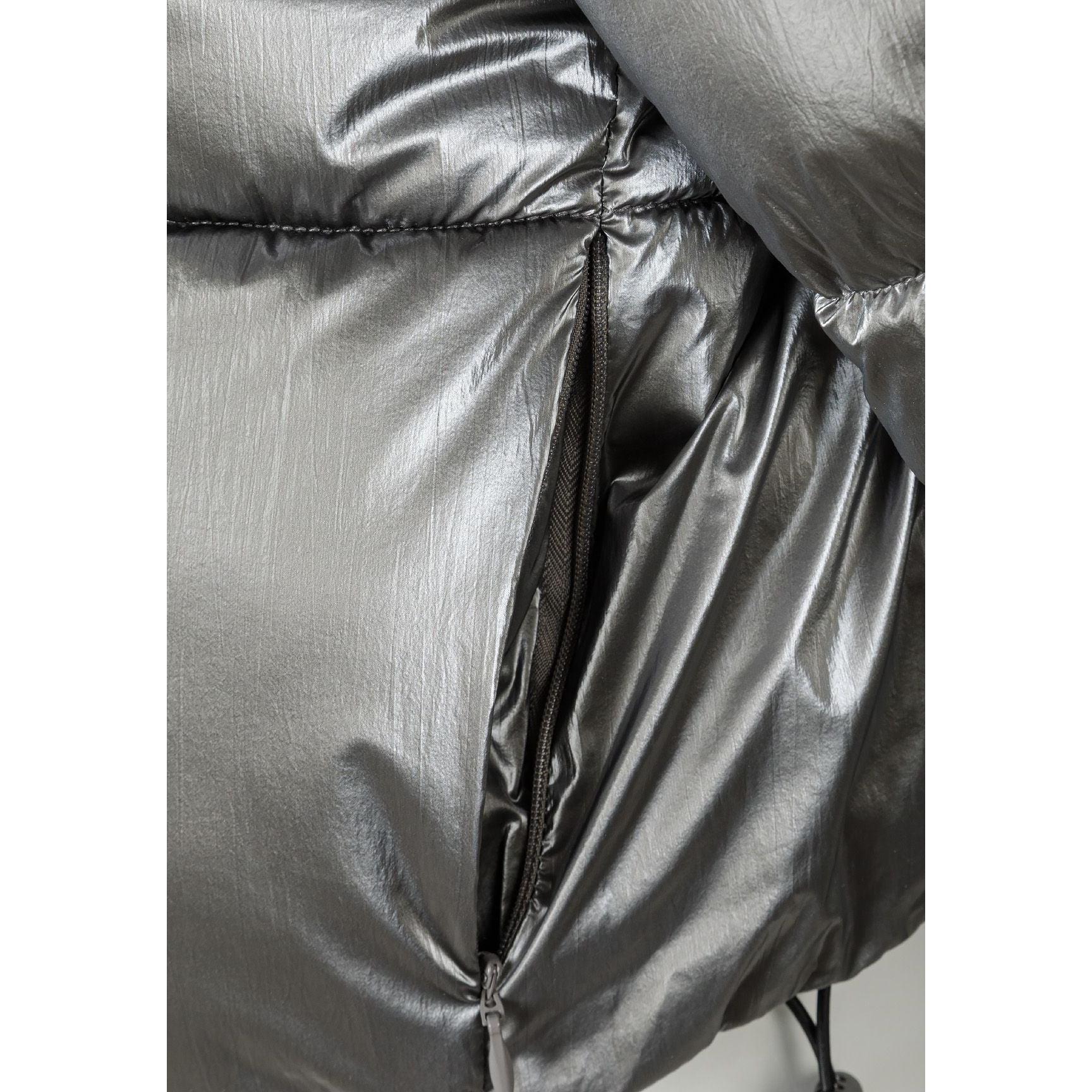 Close-up detail of metallic silver jacket showing zip and fabric texture