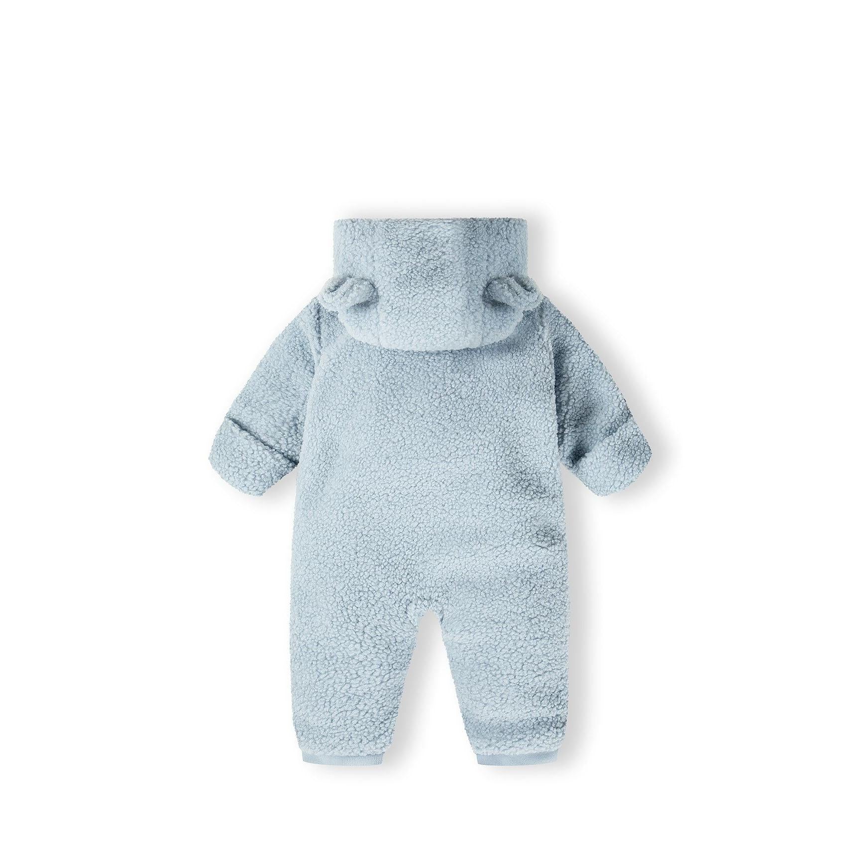 Close-up detail of light blue sherpa fabric texture with full-length zipper and cream jersey cotton lining visible inside