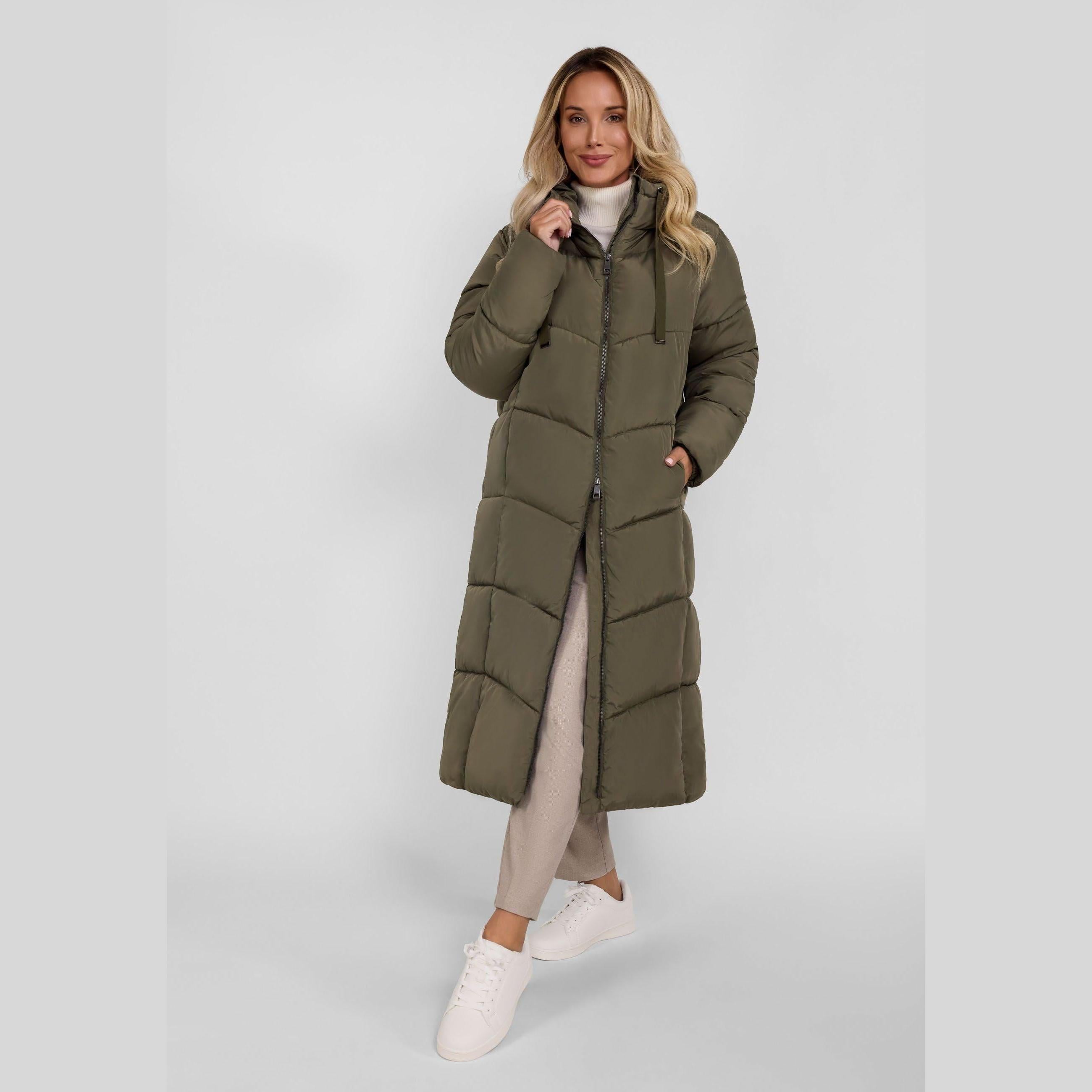 Woman wearing olive green long quilted puffer coat with hood up, full body front view against white background