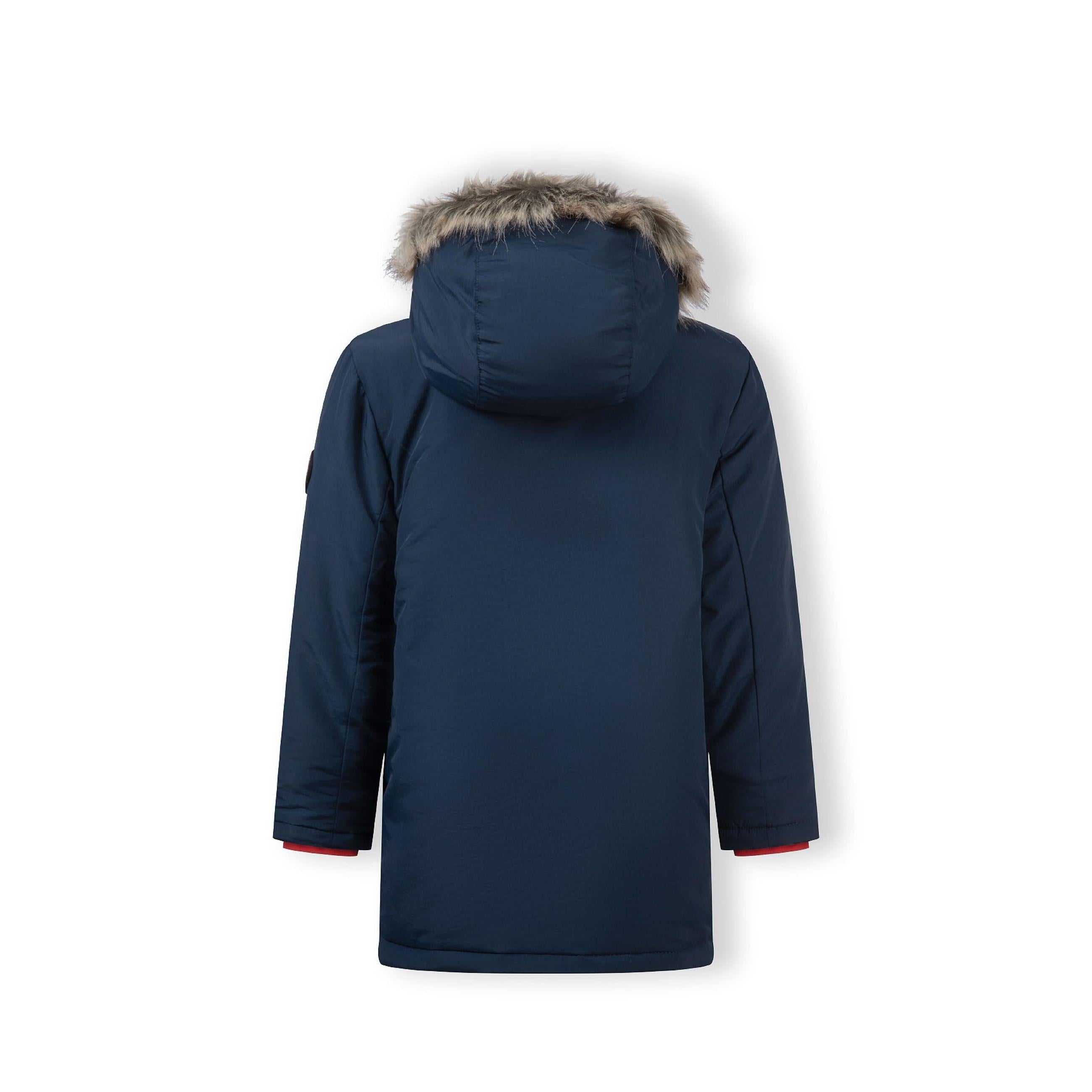 Close-up detail of navy parka pocket with button closure and red accent tab showing fabric texture