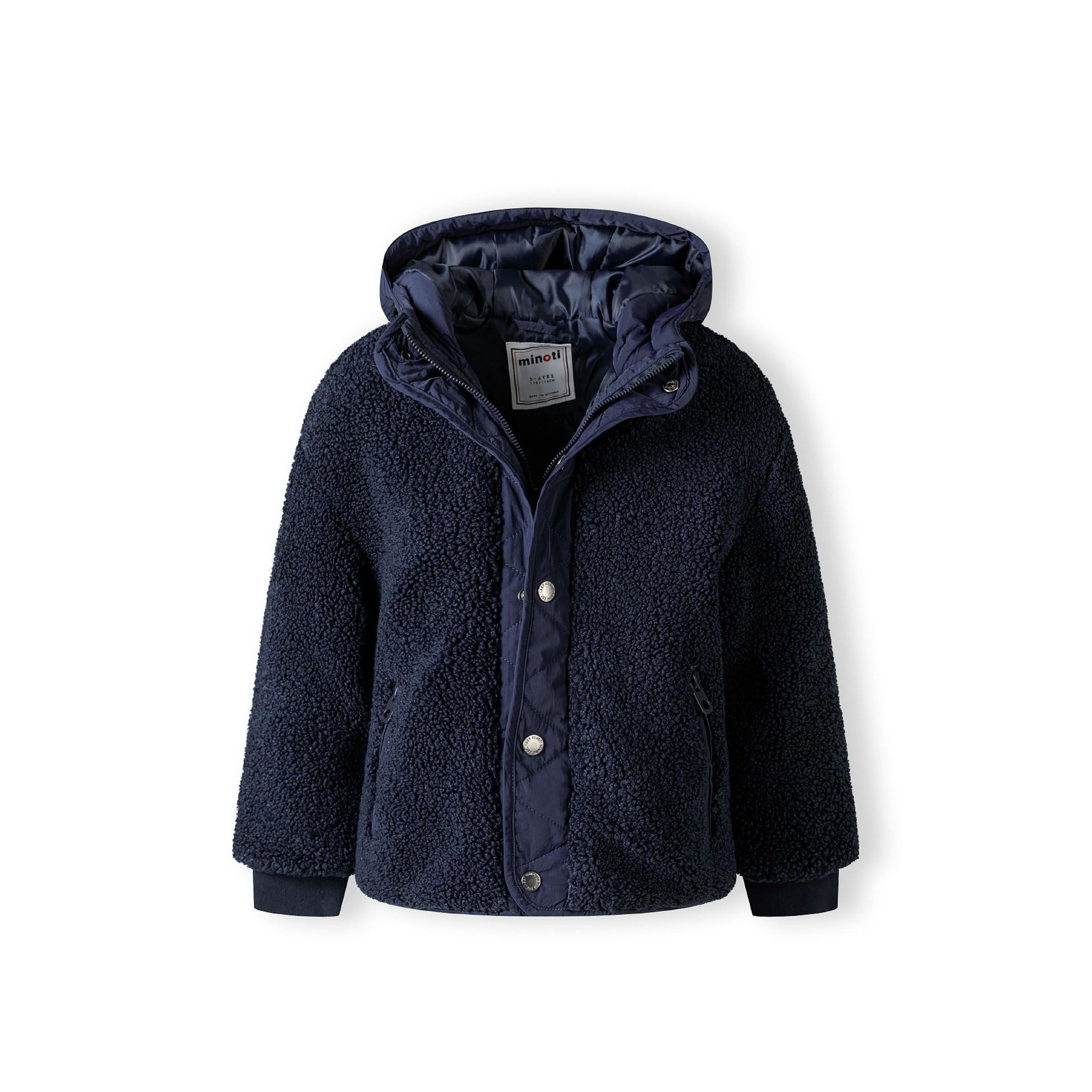 Close-up detail of navy borg jacket showing zip pocket with navy zipper pull on textured sherpa fabric