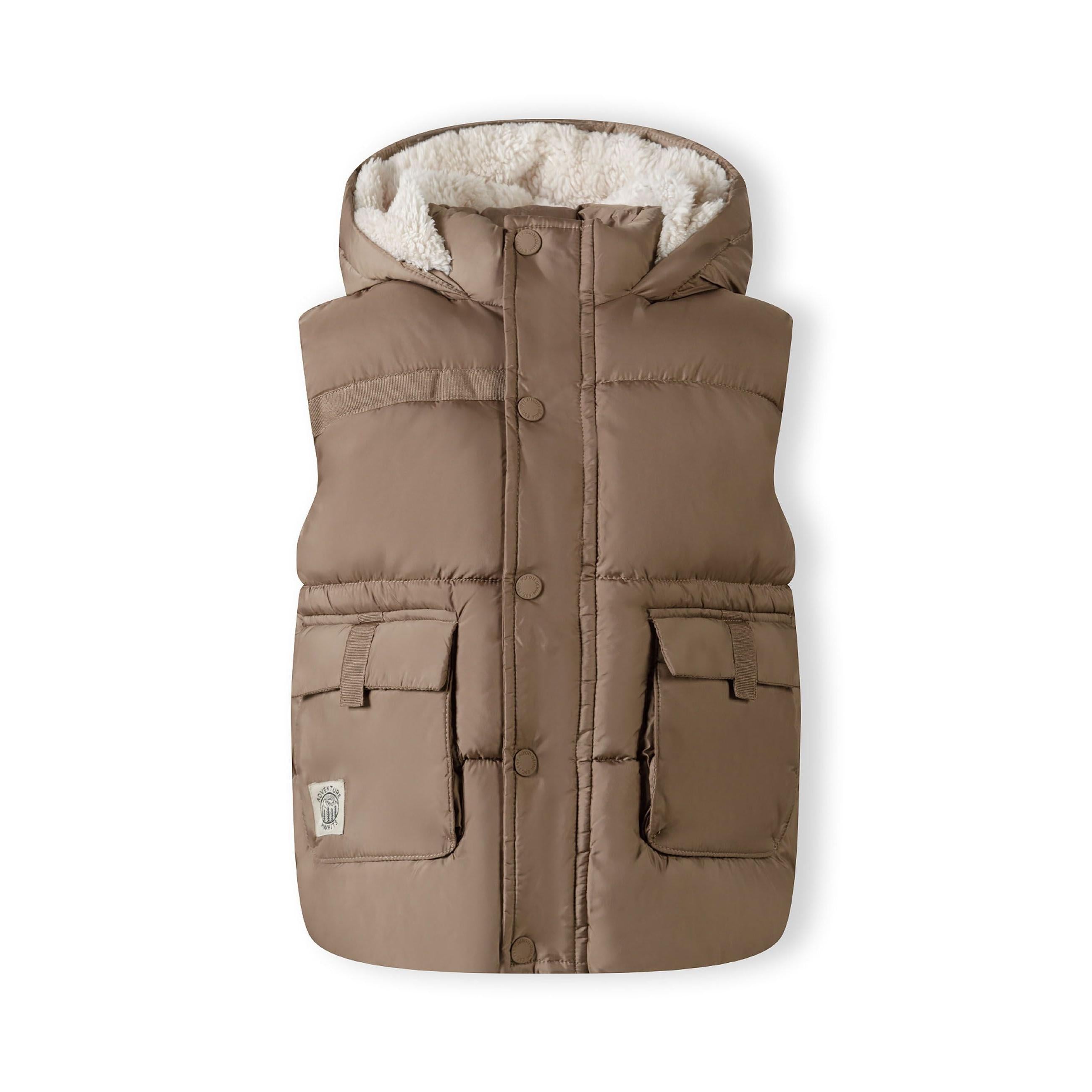 Flat lay of beige quilted hooded gilet showing teddy fleece lining, zip closure and patch pockets on white background