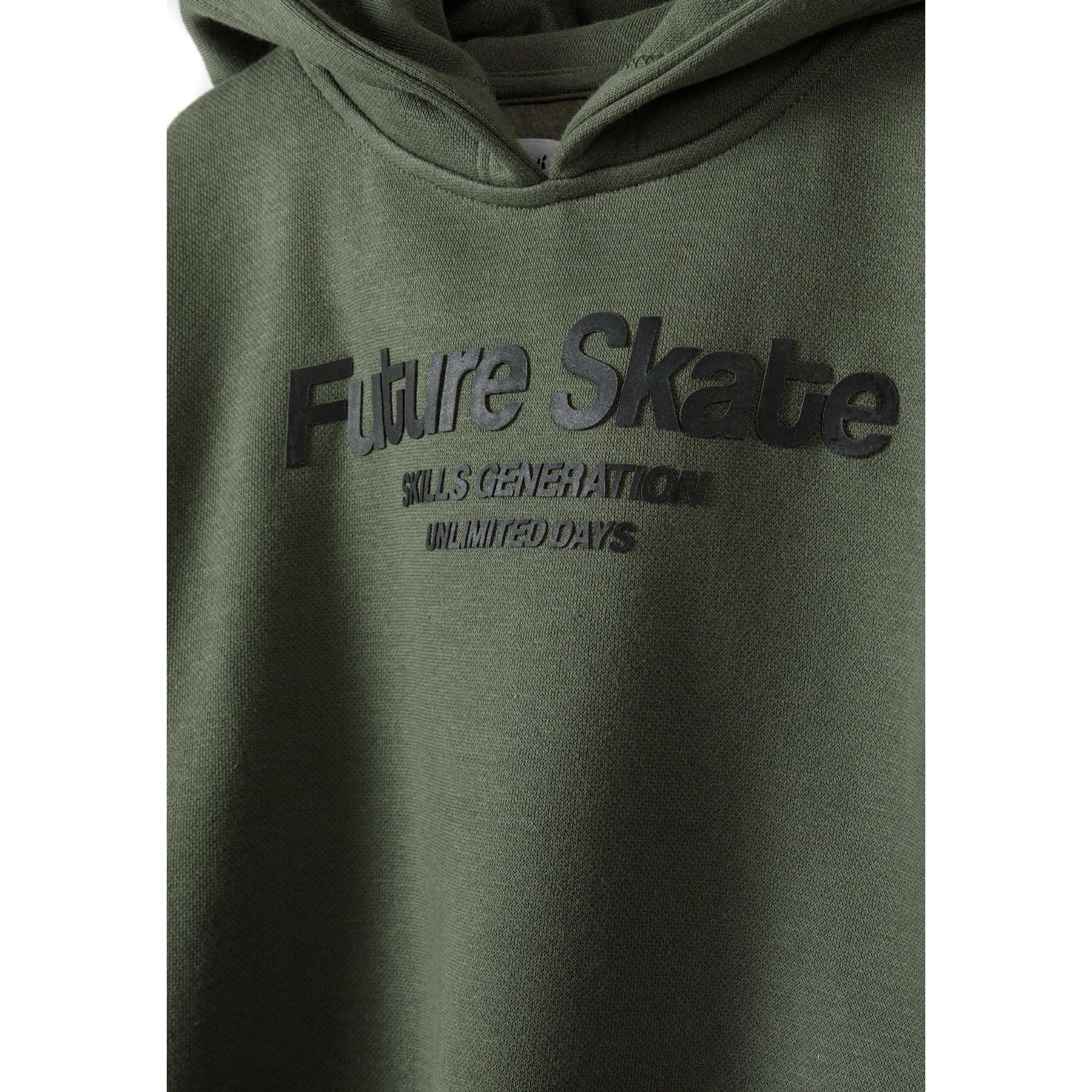 Close-up detail of khaki jogger pants showing drawstring waistband and Future Skate vertical text print on side seam