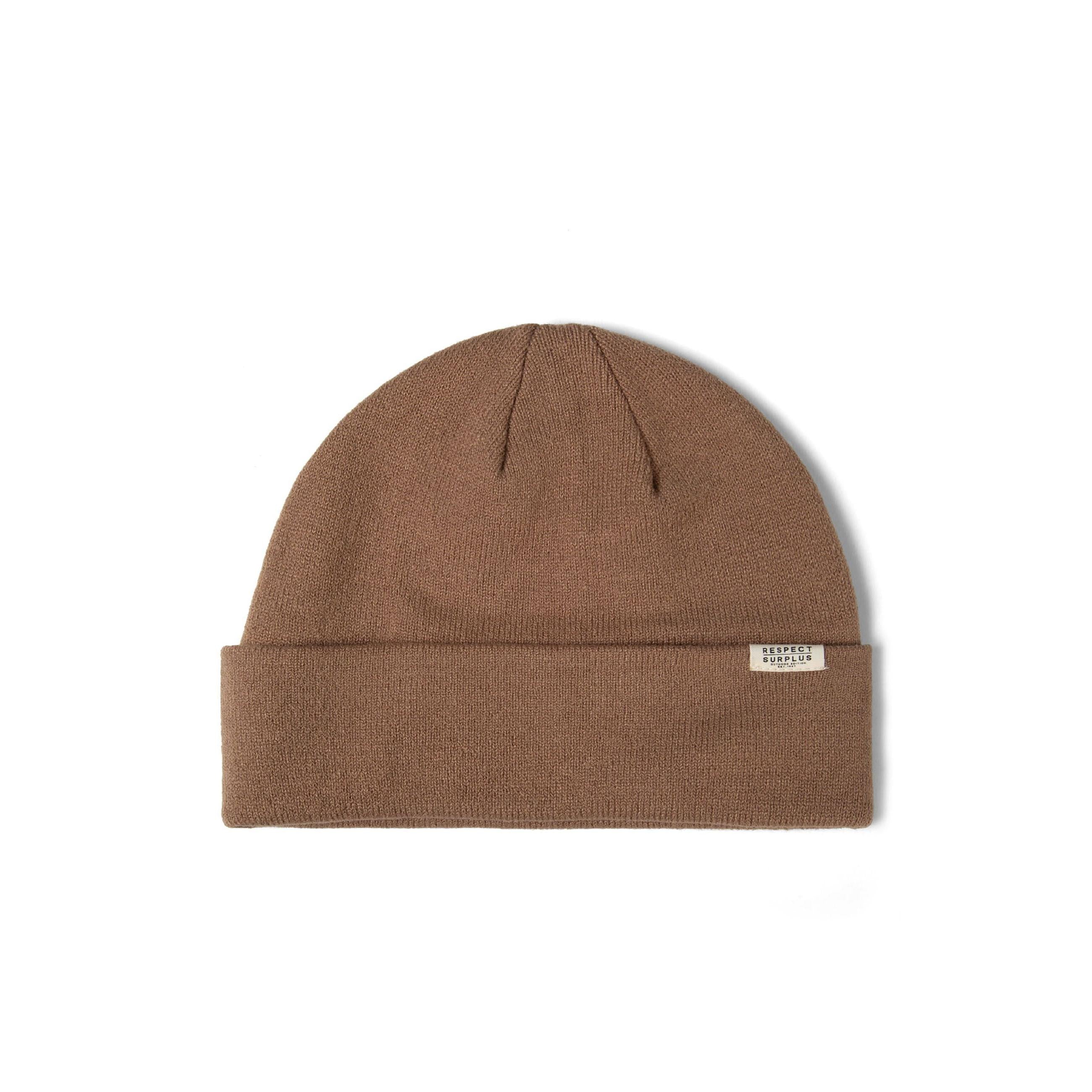 Single brown ribbed beanie hat with fold-up cuff and white brand label displayed flat on white background