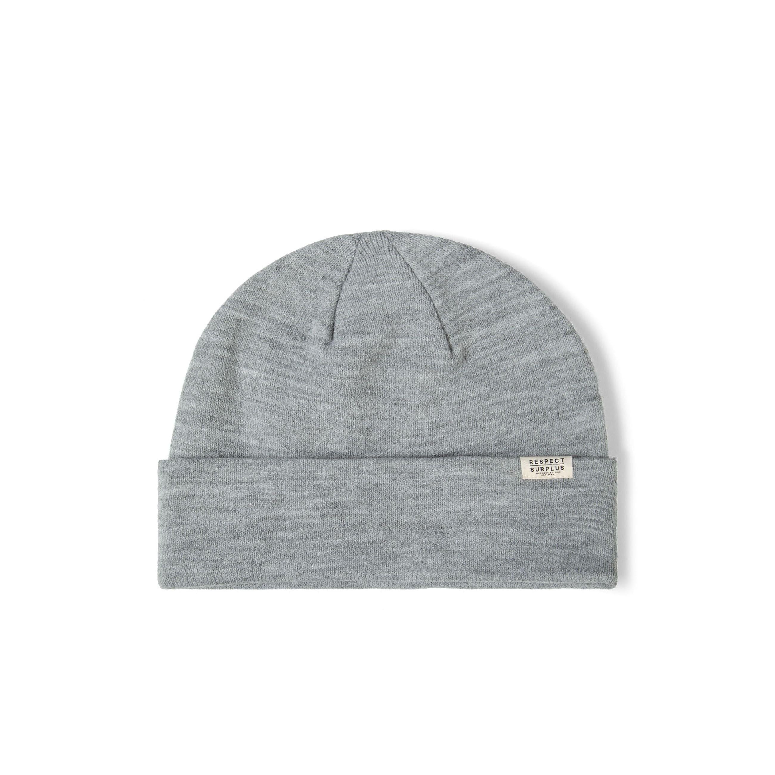 Single grey ribbed beanie hat with fold-up cuff and white brand label displayed flat on white background