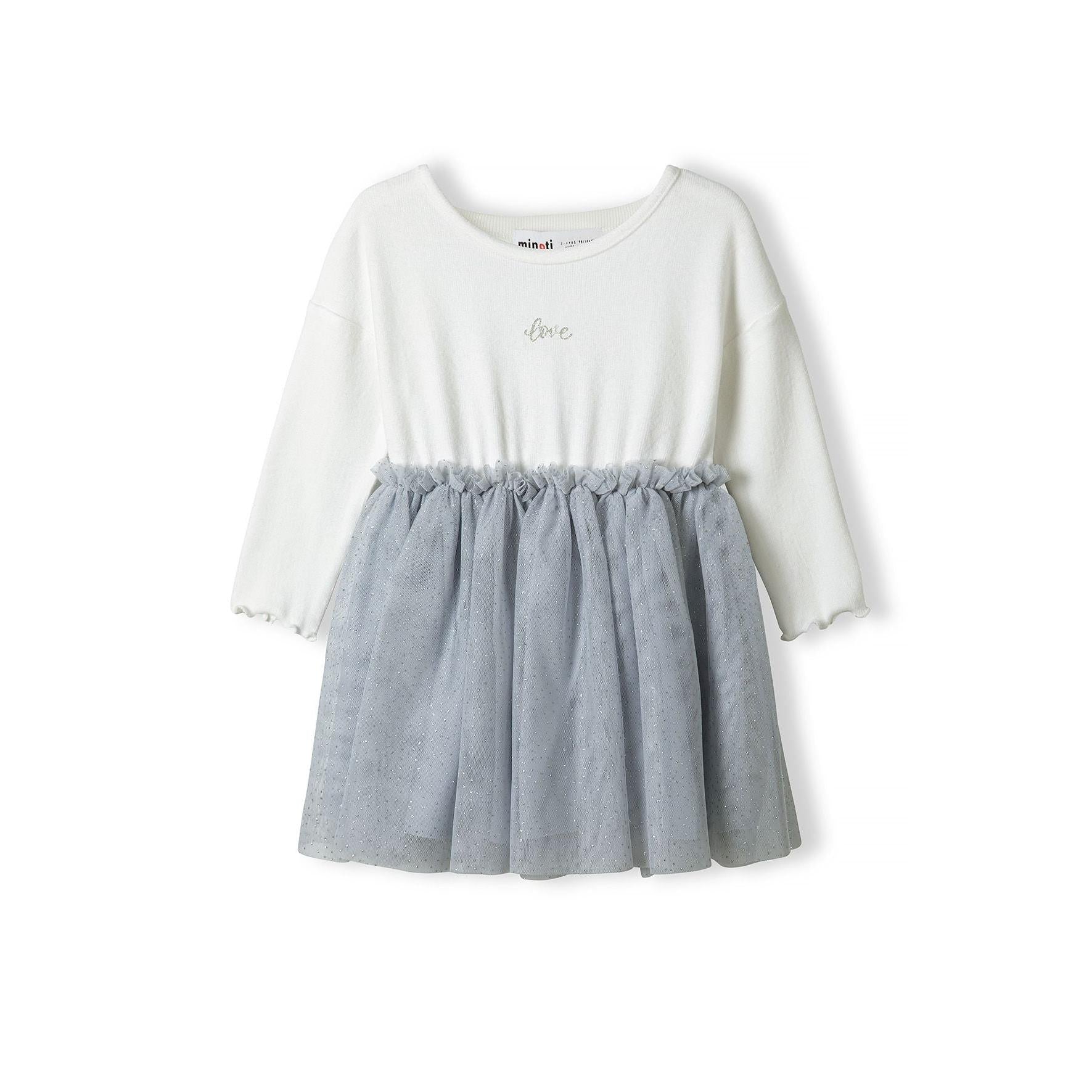 Flat lay of cream and grey mesh dress showing waffle jersey top and flowing tulle skirt on white background