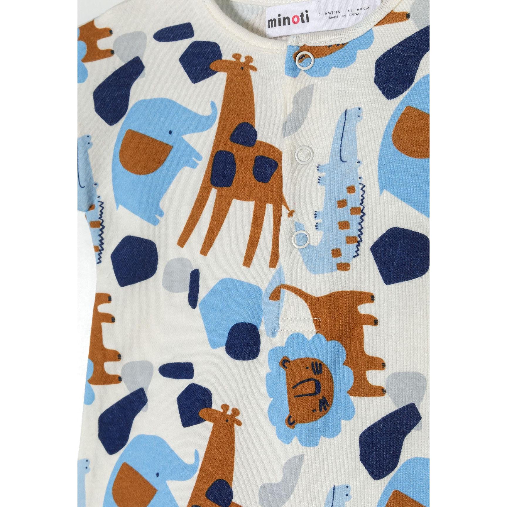 Close-up detail of safari print romper showing colorful animal pattern with giraffes, elephants, and lions in orange, blue and navy on cream background