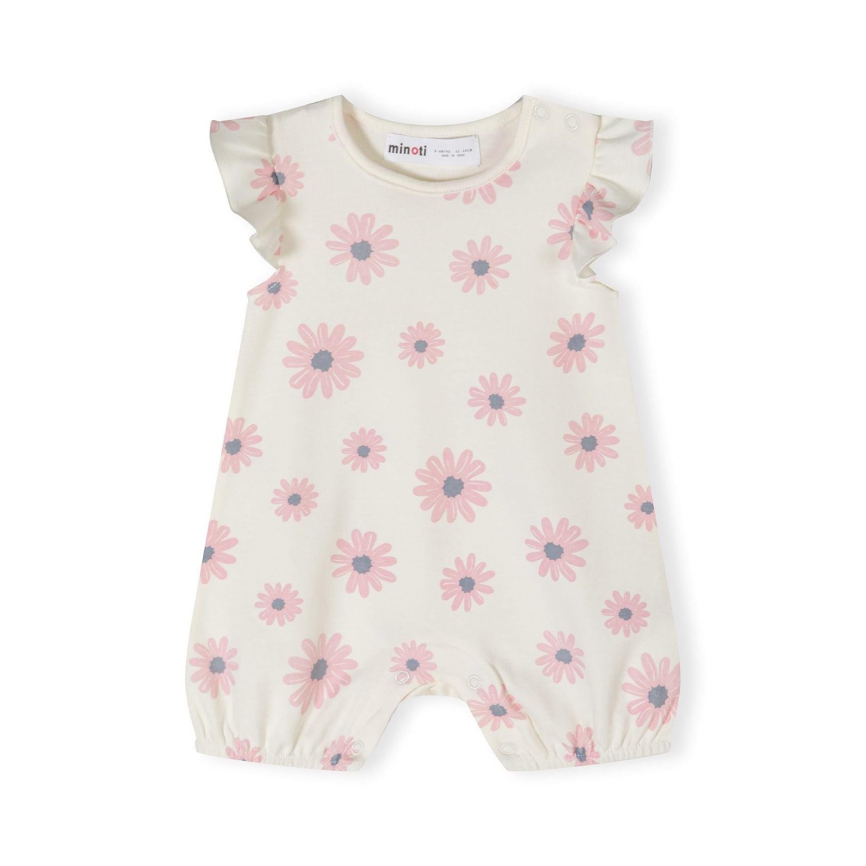 Close-up of cream romper with pink daisy pattern showing frill sleeve detail and Minoti label at neckline on white background