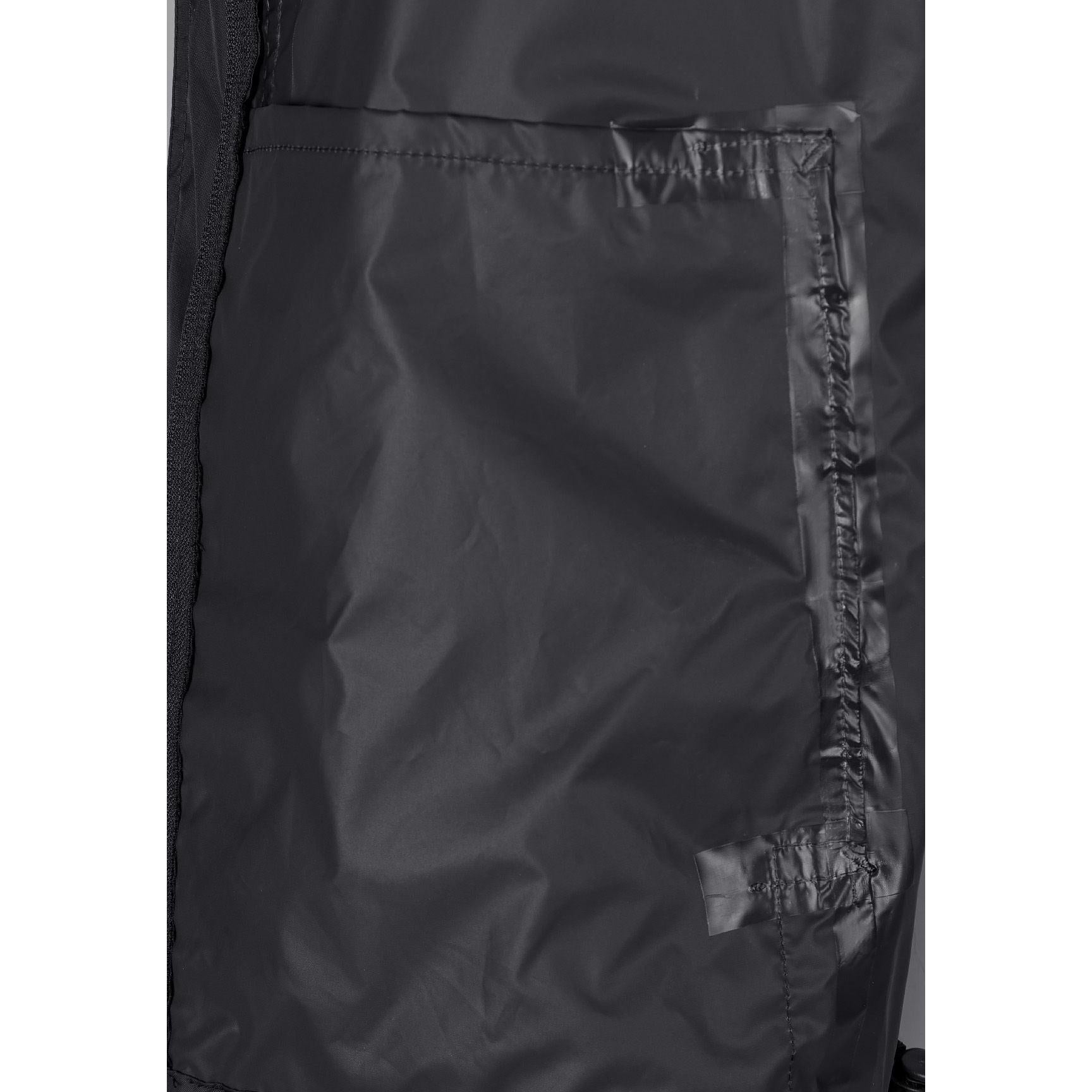 Close-up interior view of black waterproof jacket showing internal pockets and construction details