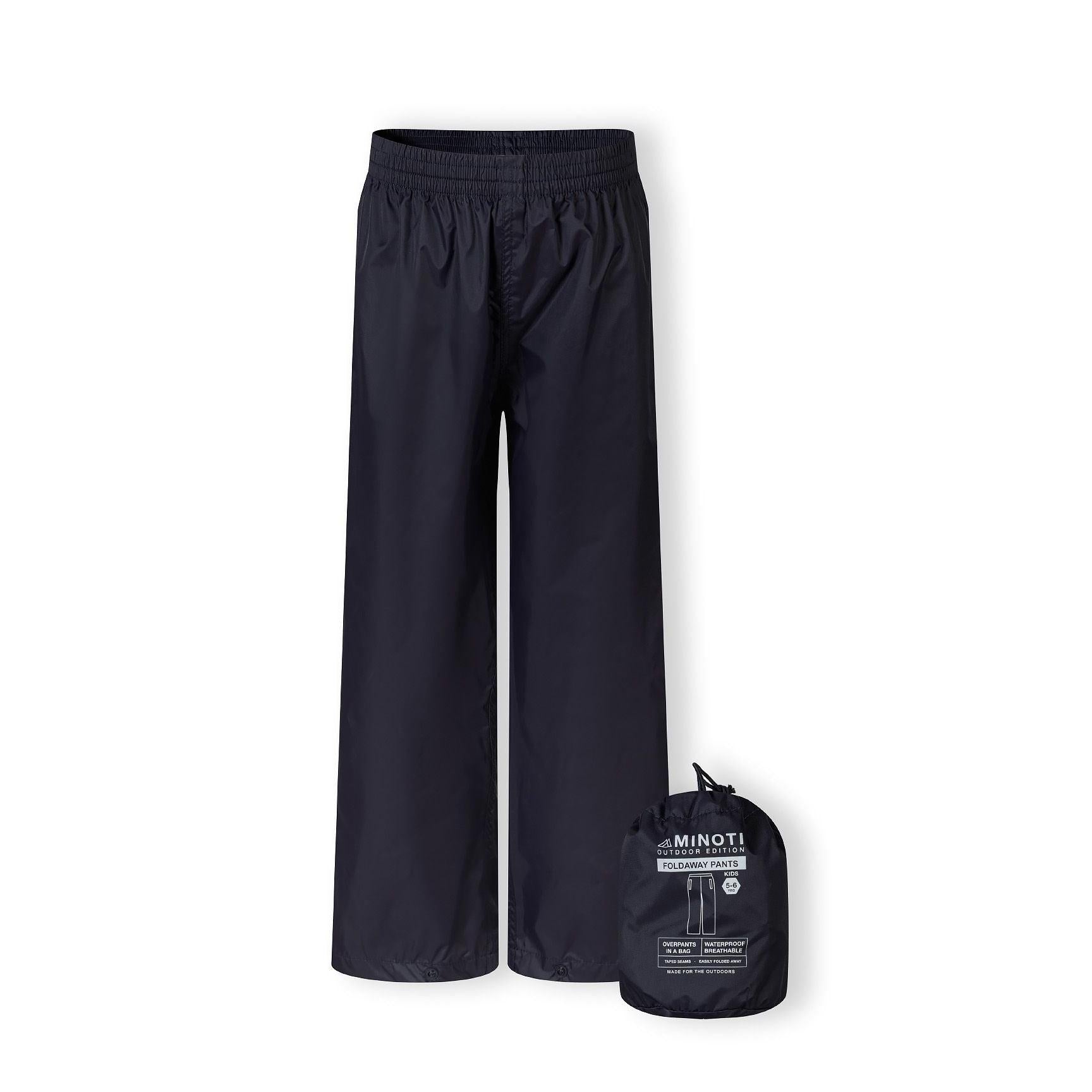 Close-up detail of navy waterproof overpants showing elasticated waistband and packaway fabric construction