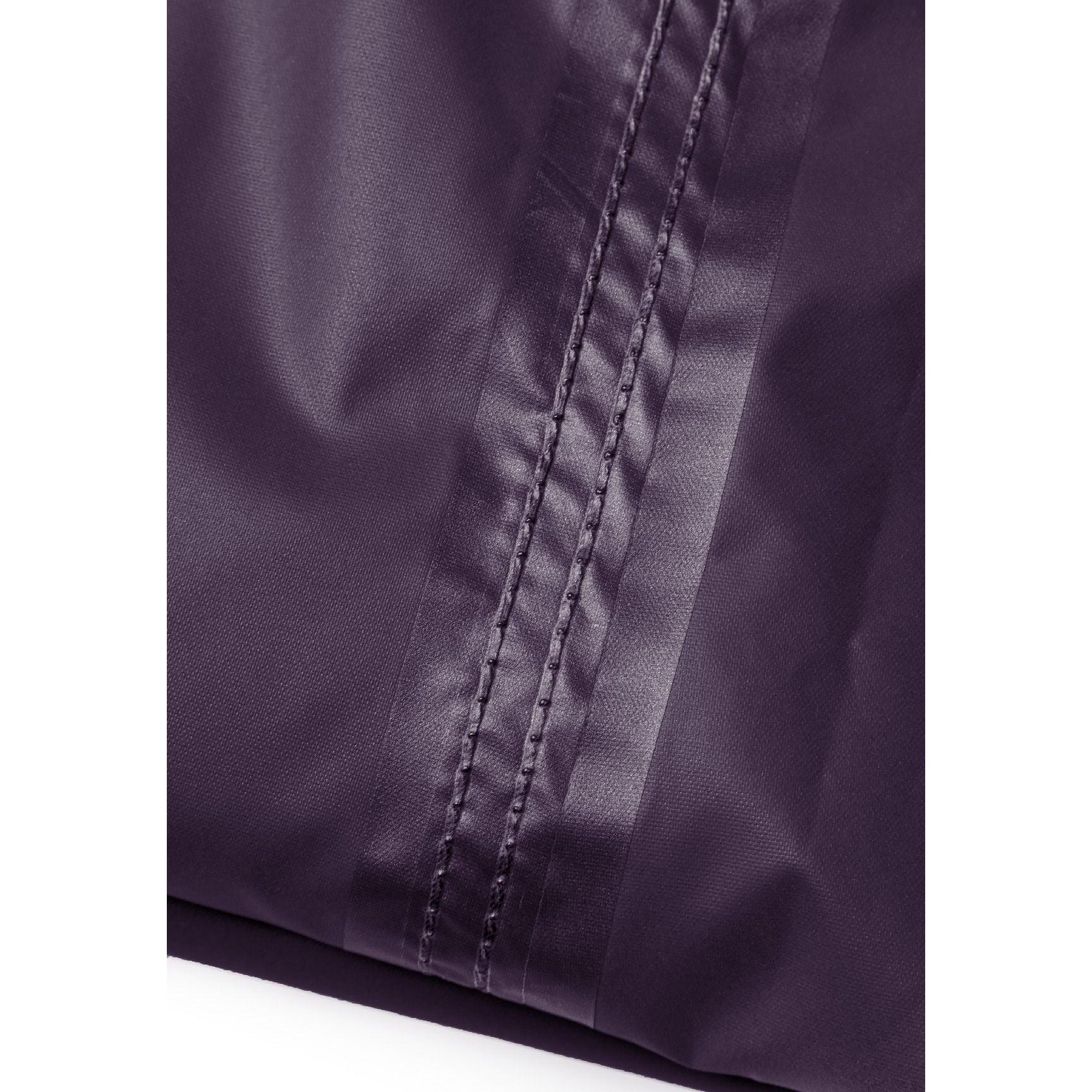 Close-up detail of purple waterproof fabric showing seam construction and material texture, highlighting quality stitching and waterproof properties