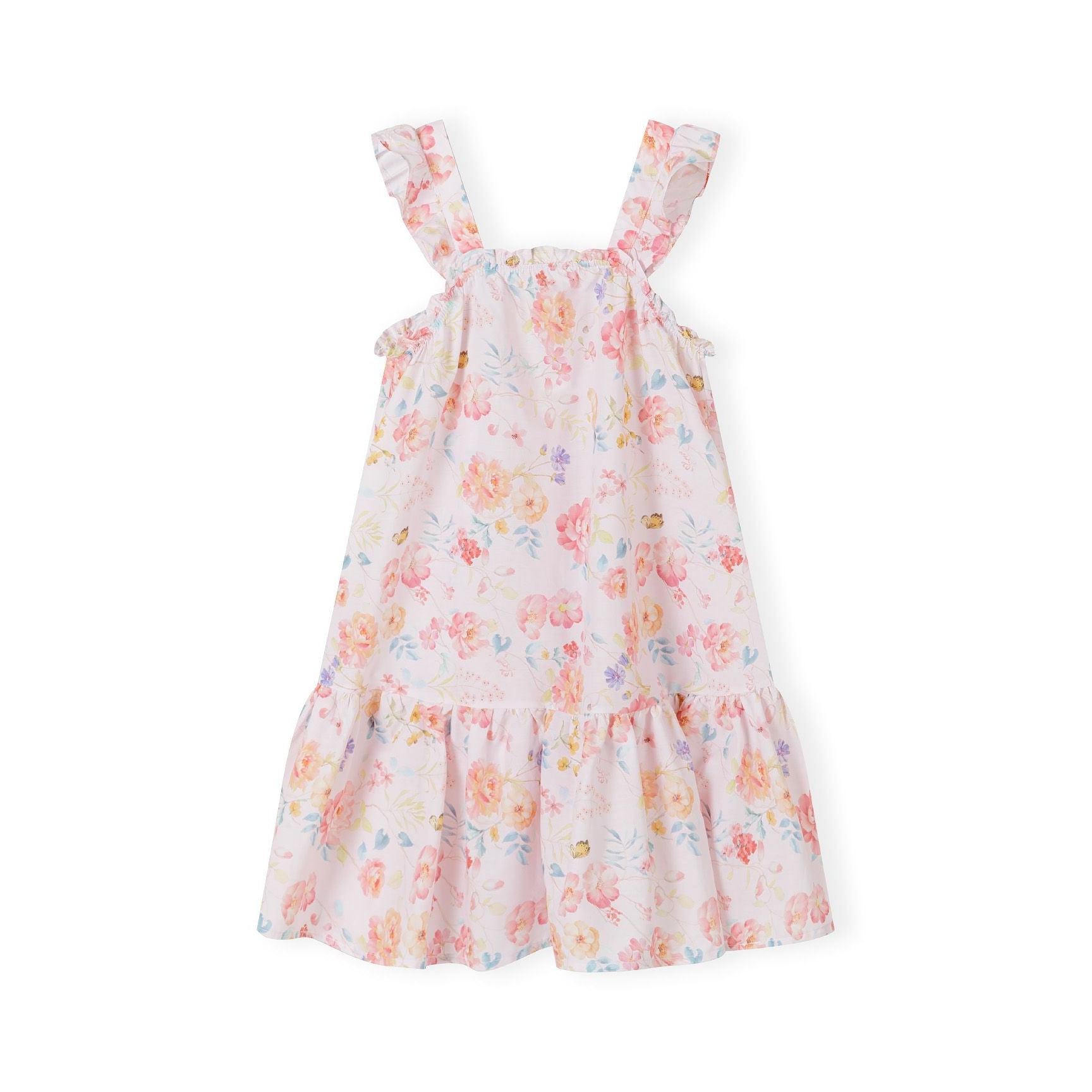 Flat lay of pink floral cotton dress with ruffled shoulder straps and tiered design against white background