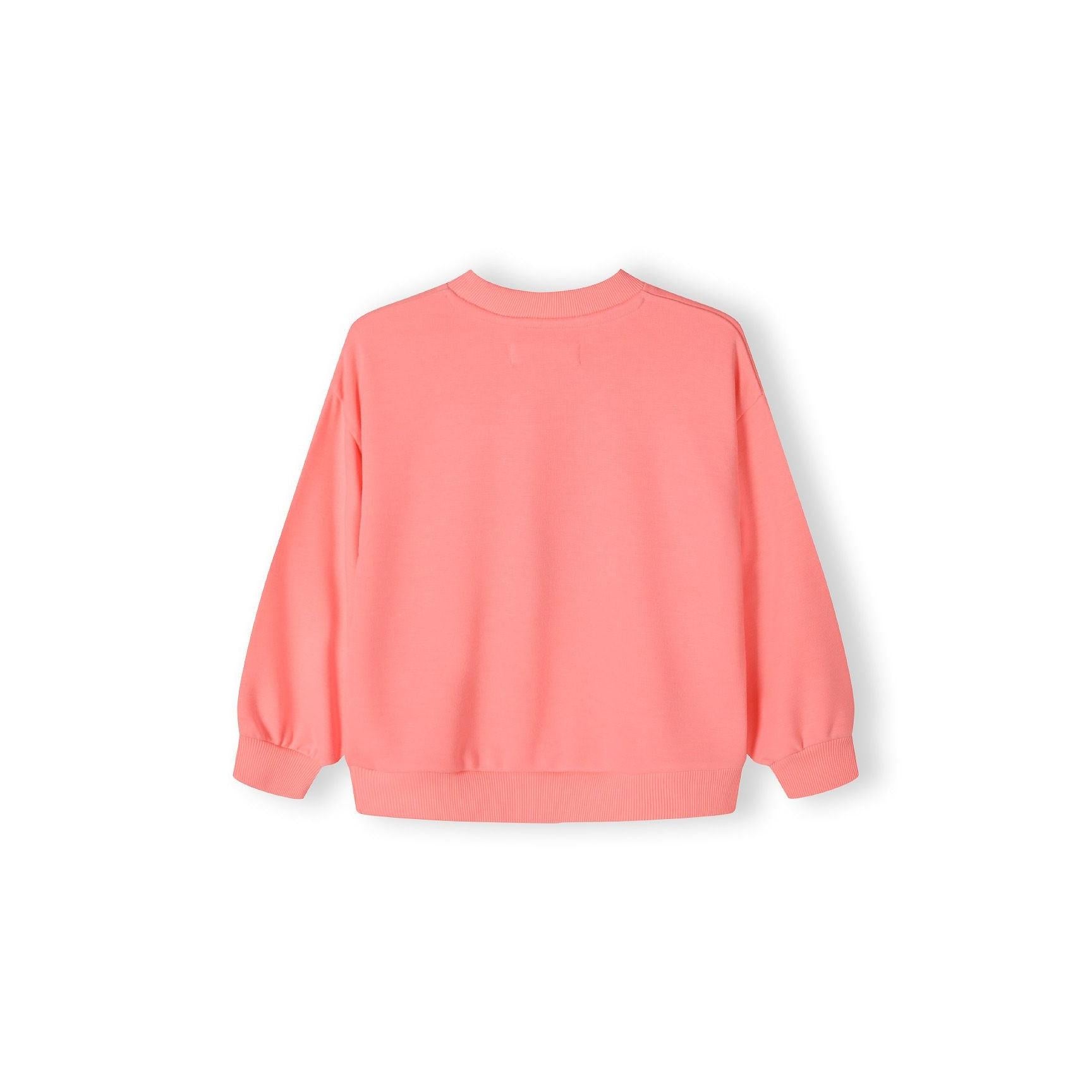 Back view of coral crew neck sweatshirt showing plain design with ribbed cuffs and hem against white background