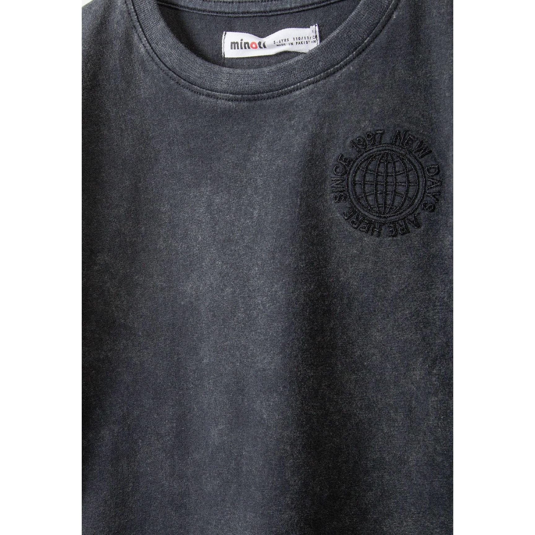 Close-up detail of washed grey fleece shorts showing elasticated waistband with white label and soft fabric texture