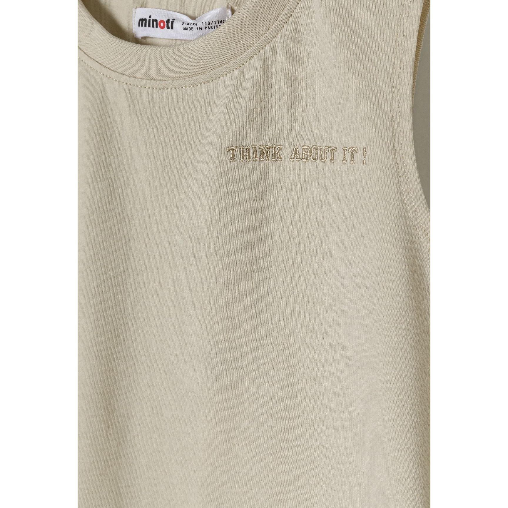 Close-up detail of beige shorts waistband showing elasticated fabric and black drawstring toggle