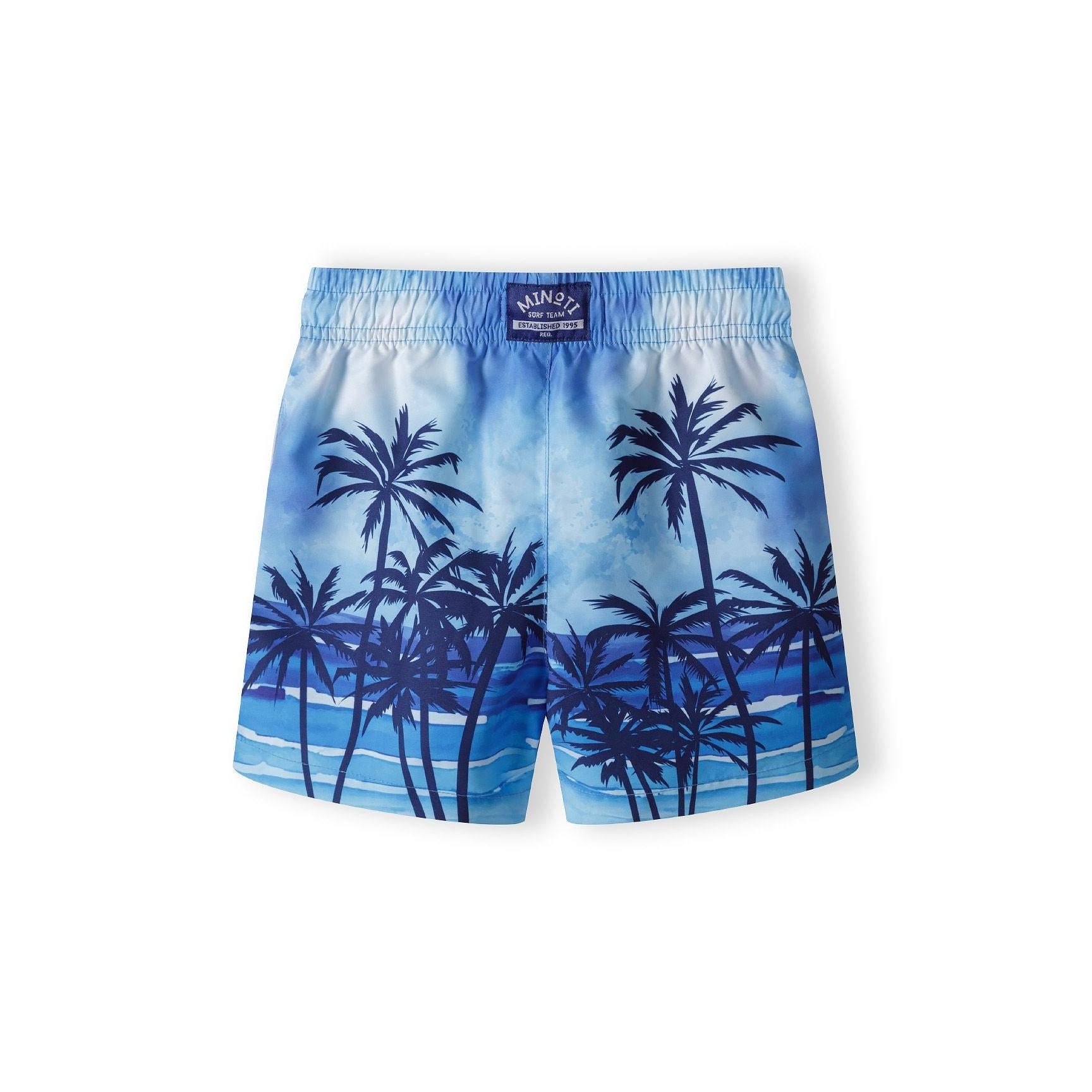 Back view of light blue palm print swim shorts showing Minoti brand label and elastic waistband detail against white background