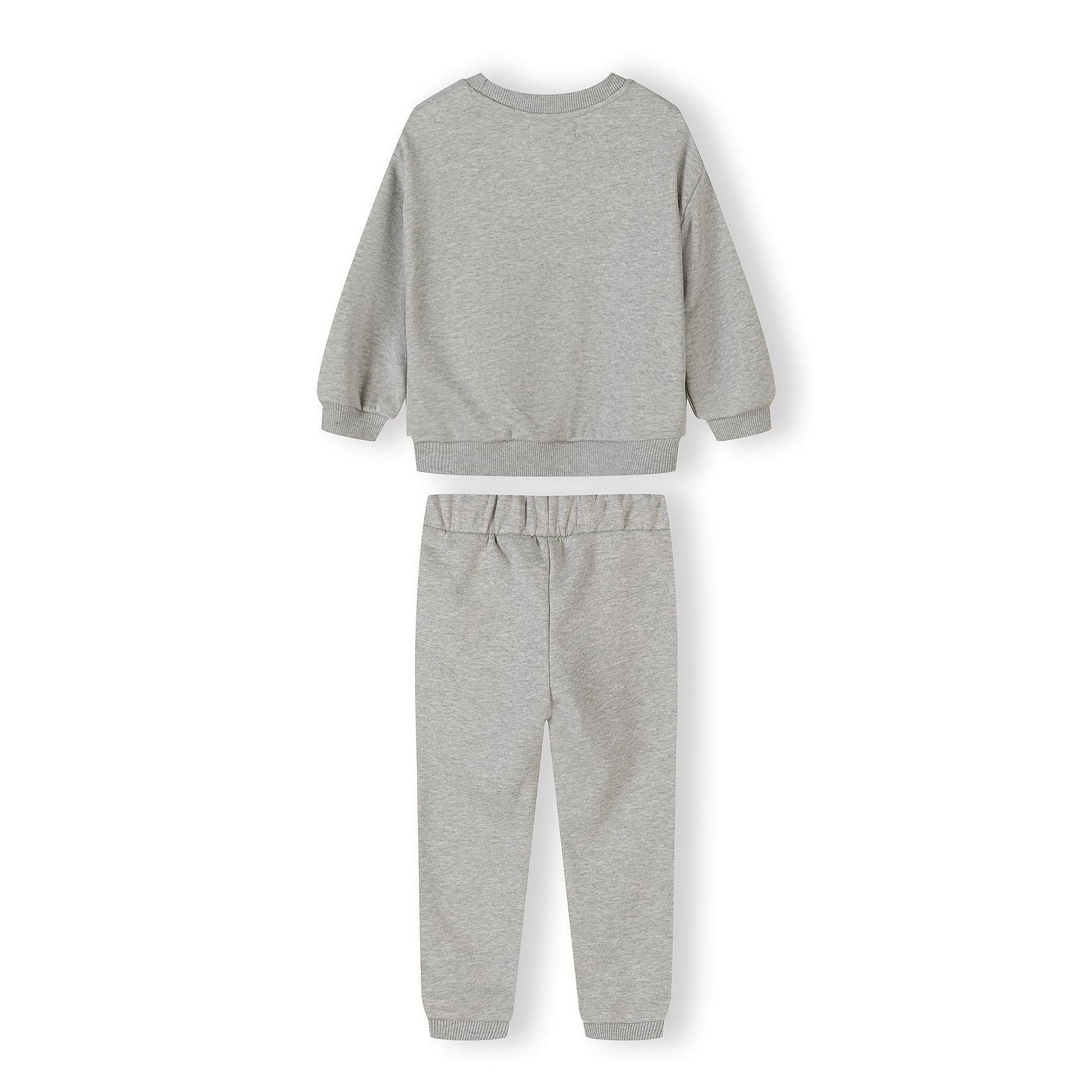 Close-up detail of pink joggers showing Minoti label and drawstring waistband with soft fabric texture