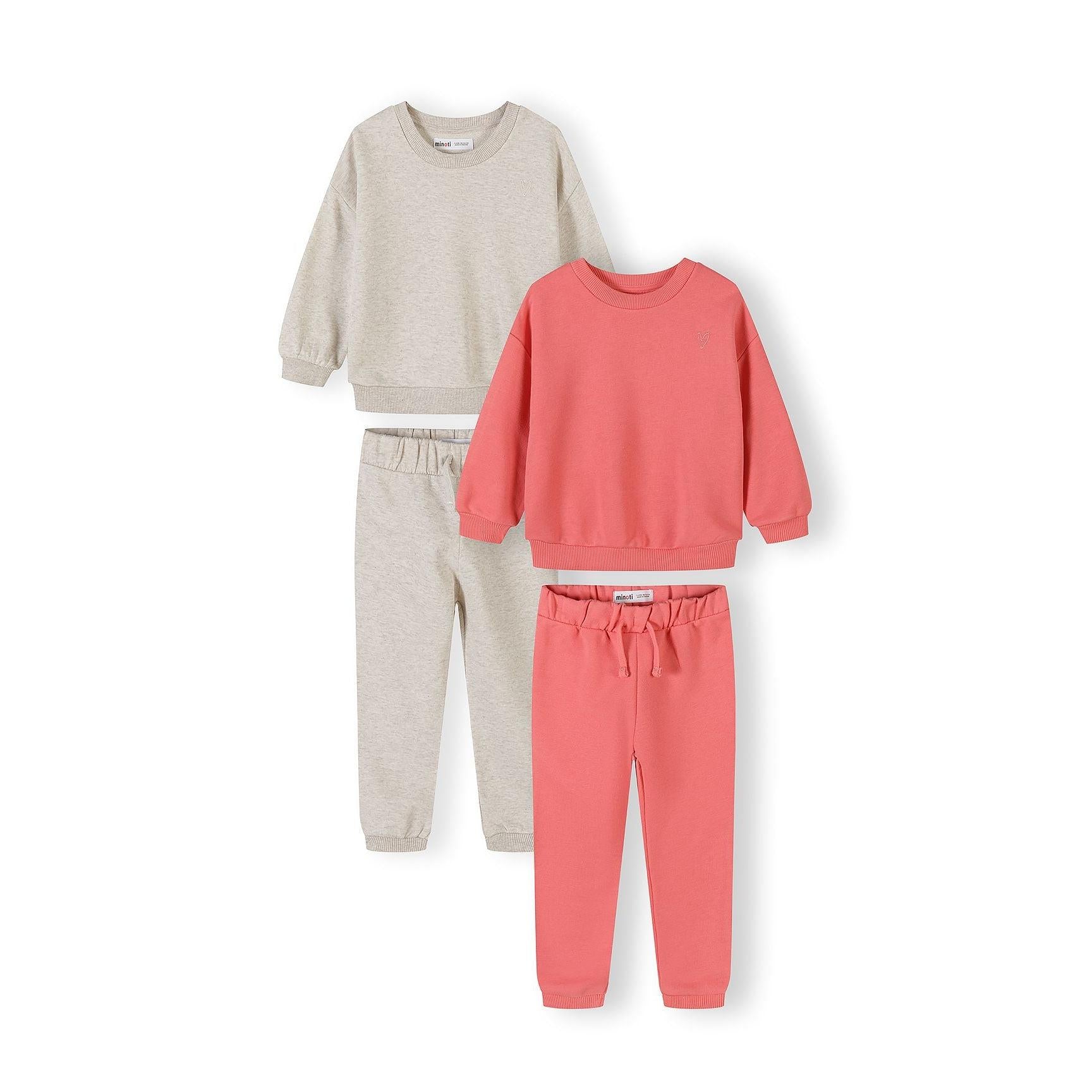 Two cotton tracksuit sets laid flat - coral and cream sweatshirts with matching joggers on white background