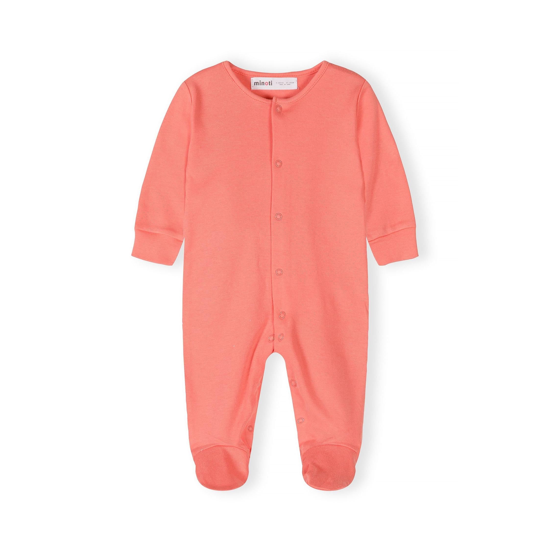 Single coral pink baby sleepsuit laid flat showing full-length snap button closure and Minoti label on white background