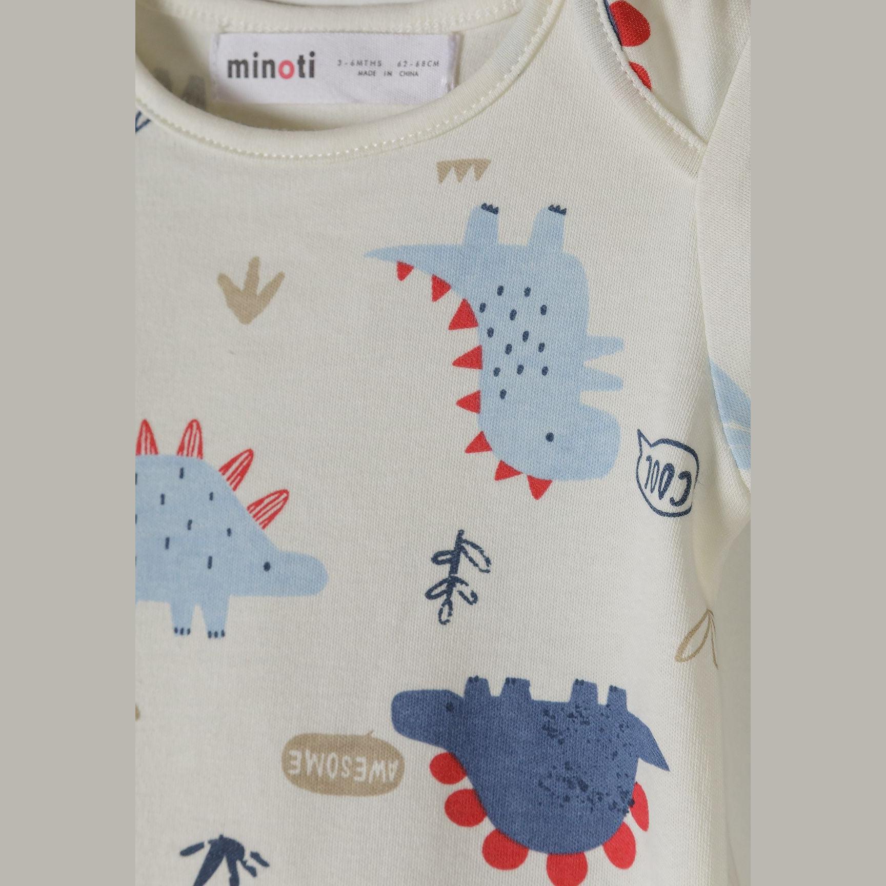 Close-up detail of cream bodysuit showing dinosaur characters with 'Hi', 'Awesome' and 'Cool' text, blue and red colour accents