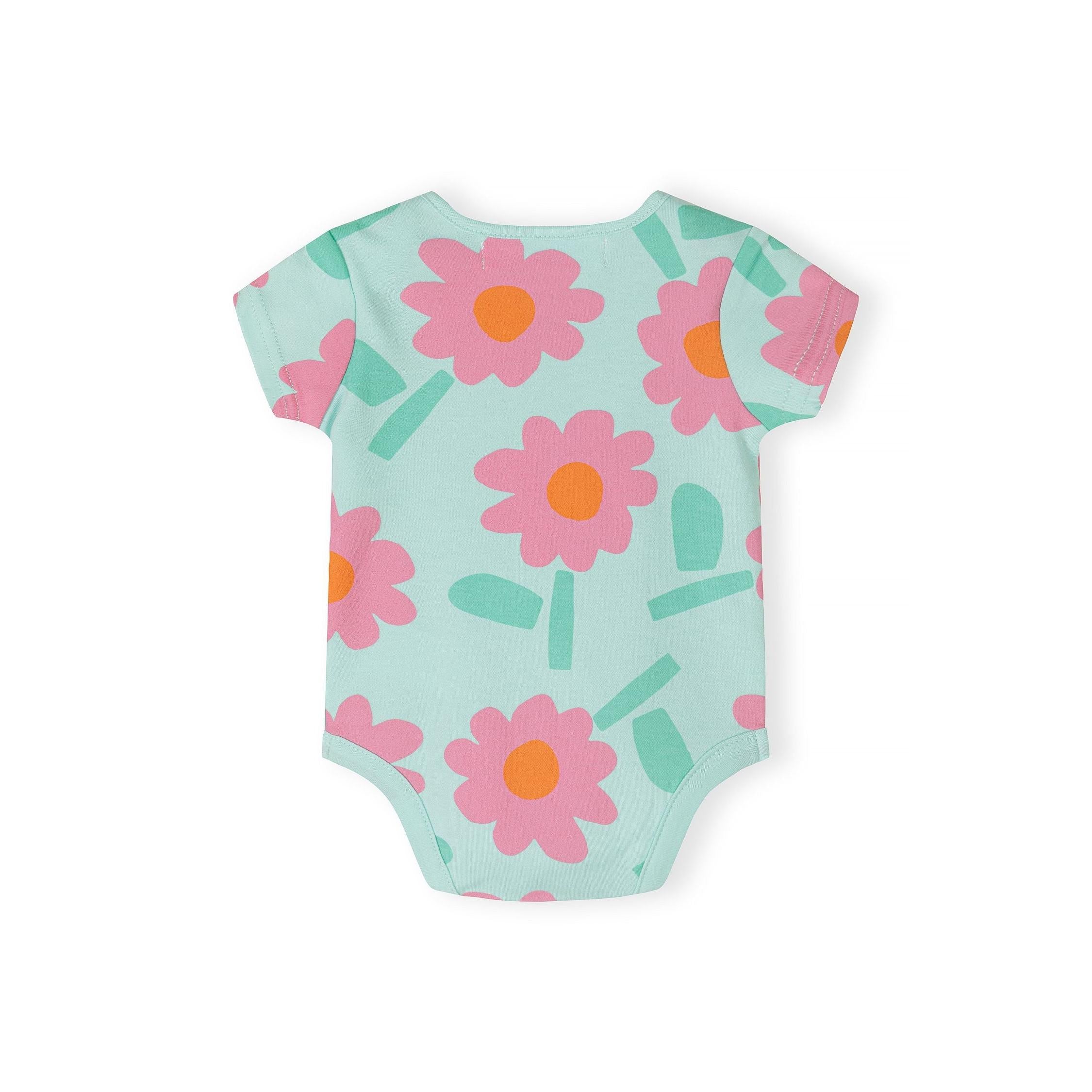 Close-up detail of mint bodysuit showing Minoti label, neckline construction and large pink daisy print with green leaves