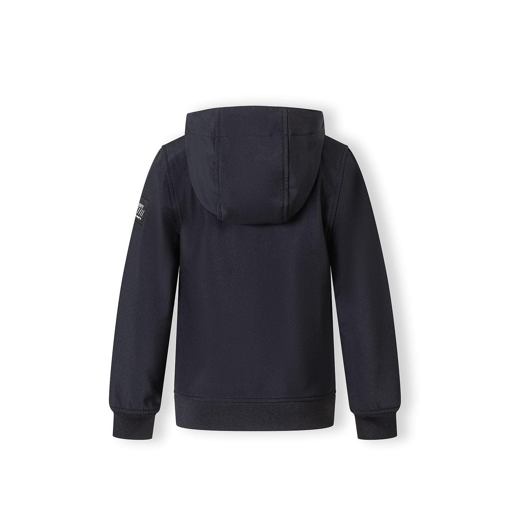 Close-up detail of black softshell jacket showing zippered side pocket with metal zipper pull and fabric texture