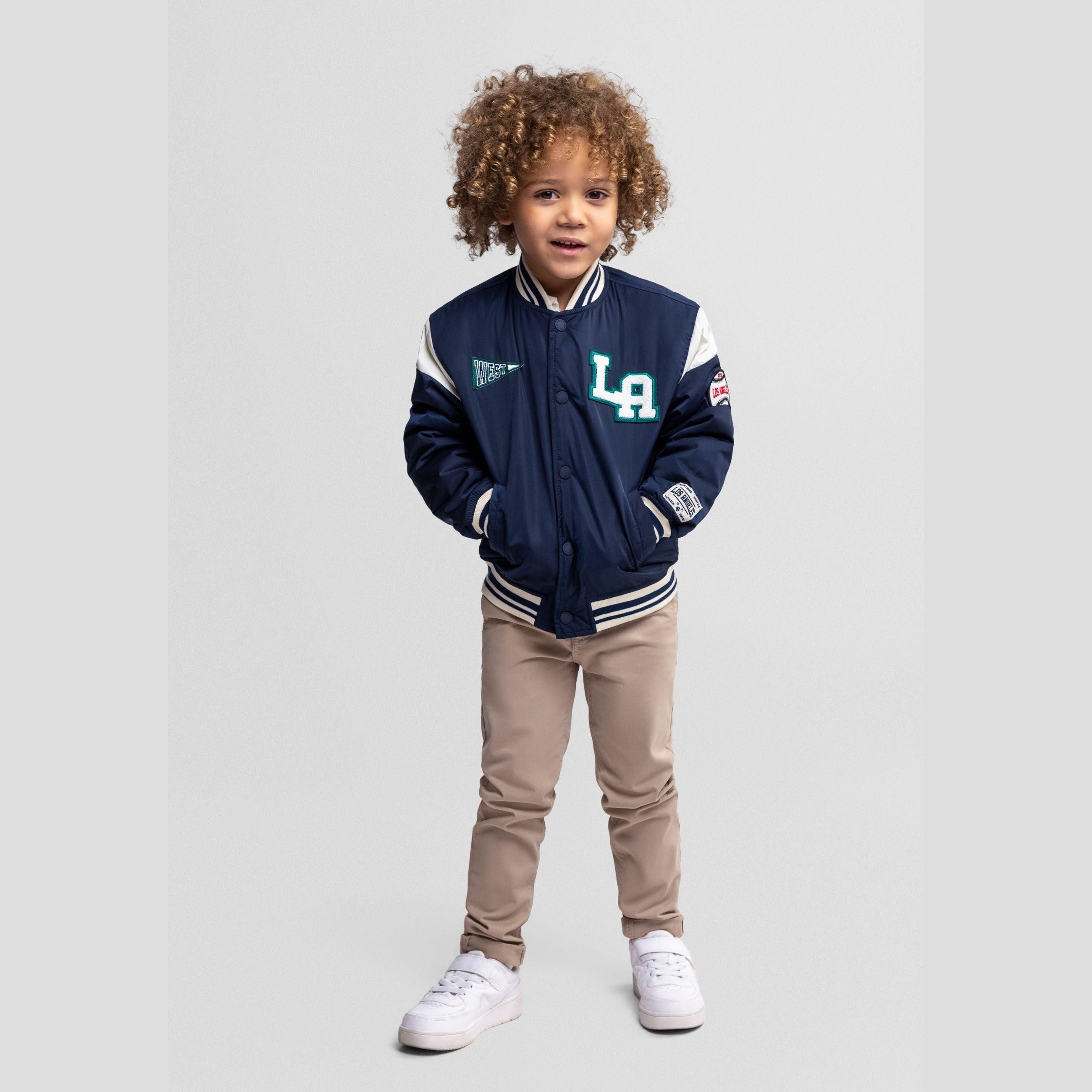 Navy varsity bomber jacket laid flat showing front view with green patches, white sleeves and ribbed trim details