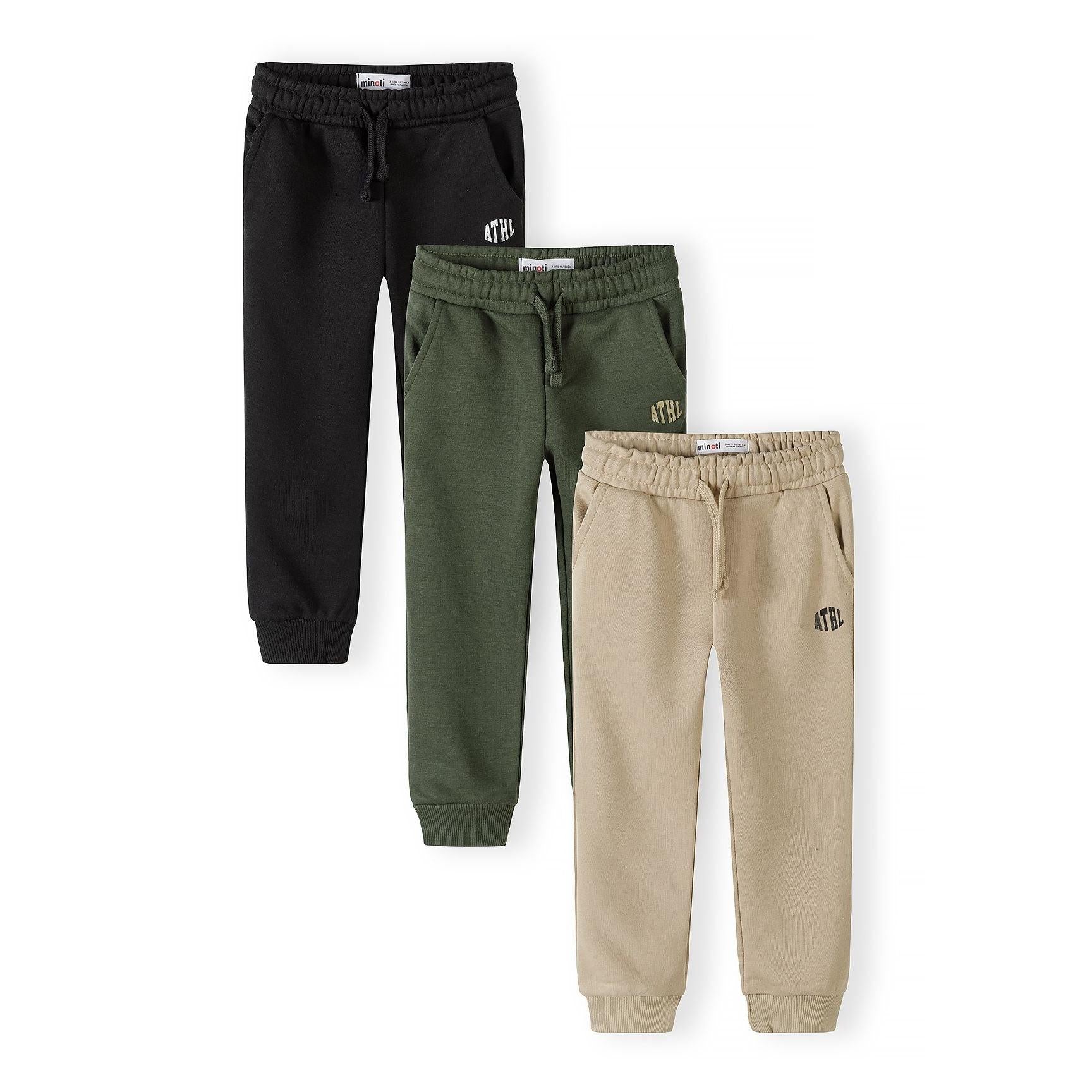 Three Minoti joggers displayed flat against white background in black, olive green and beige colours with drawstring waistbands and ATHL branding