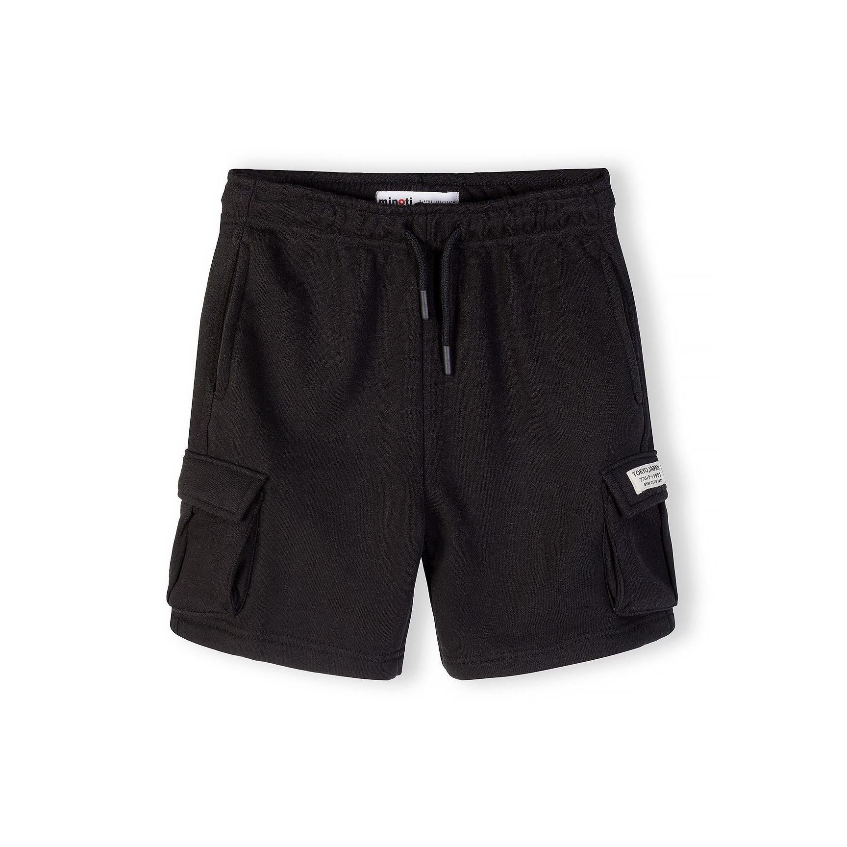 Close-up view of black cargo shorts showing elasticated waistband with drawstring and side cargo pocket details on white background