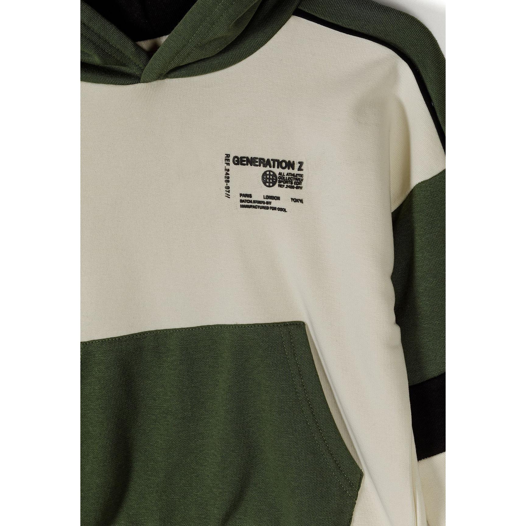 Close-up detail of Generation Z print on cream panel of hooded sweatshirt showing black text and logo design