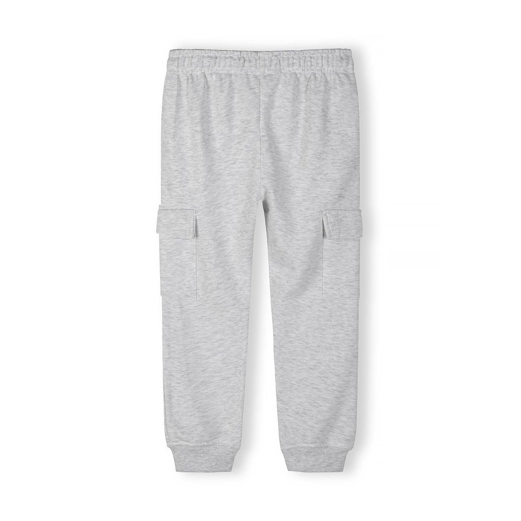 Close-up detail of light grey cargo joggers showing ribbed waistband texture and fabric quality on white background
