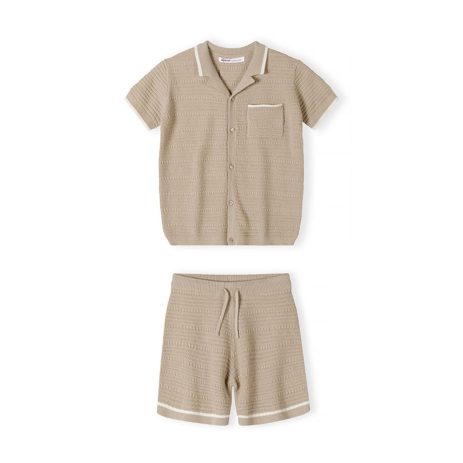 Back view of beige knitted polo shirt showing textured herringbone pattern and ribbed collar detail on white background