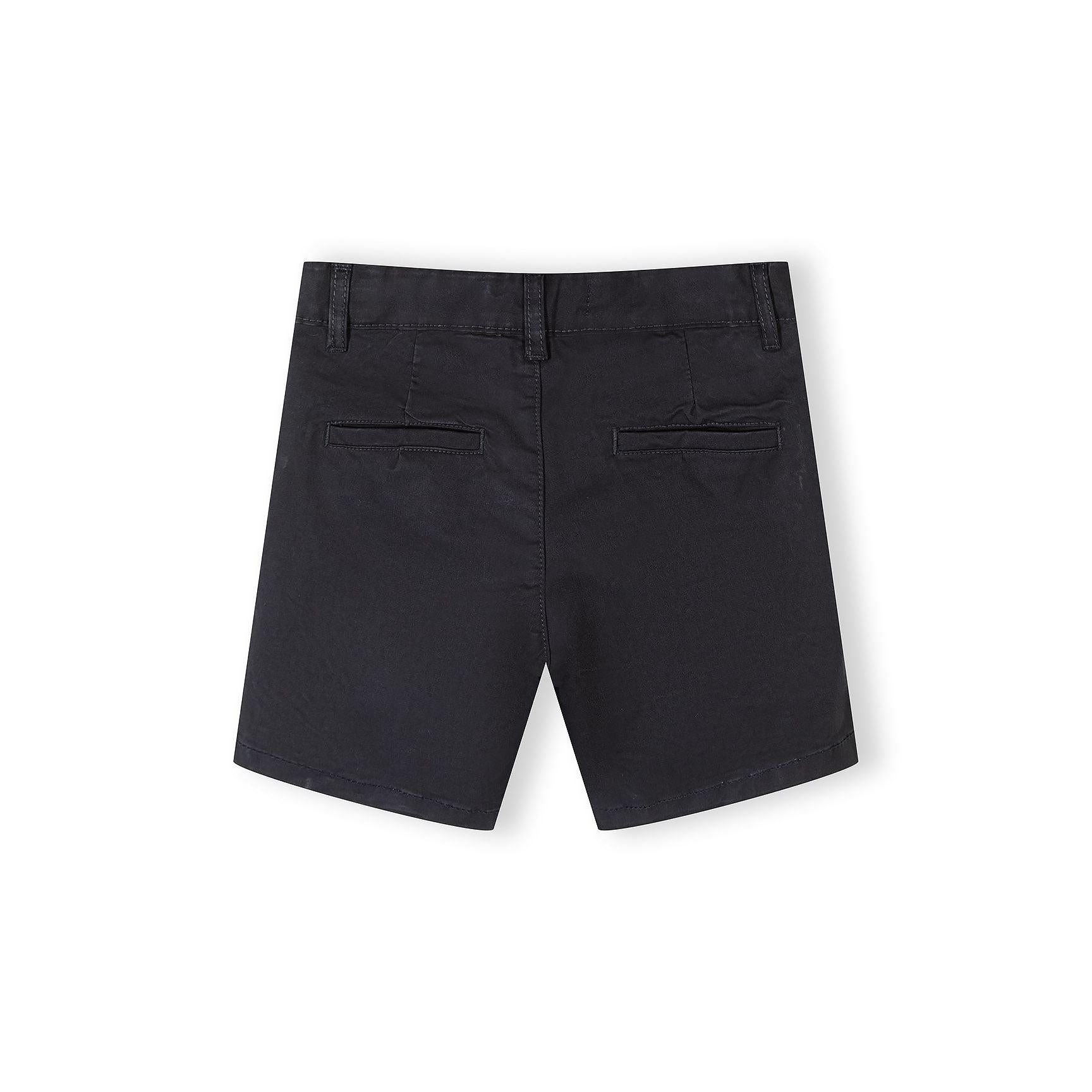 Close-up detail of navy chino shorts showing waistband construction, brown button closure, belt loop and side pocket opening