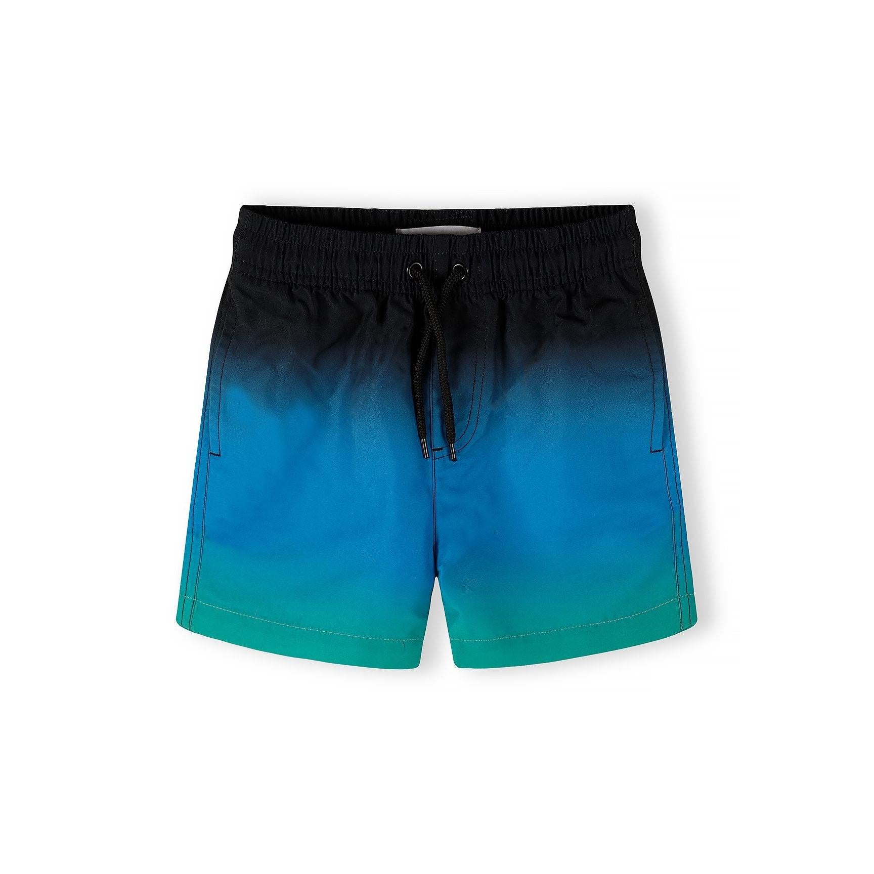 Black swimming shorts with tropical palm tree print pattern in teal and blue colours, featuring yellow drawstring waistband detail
