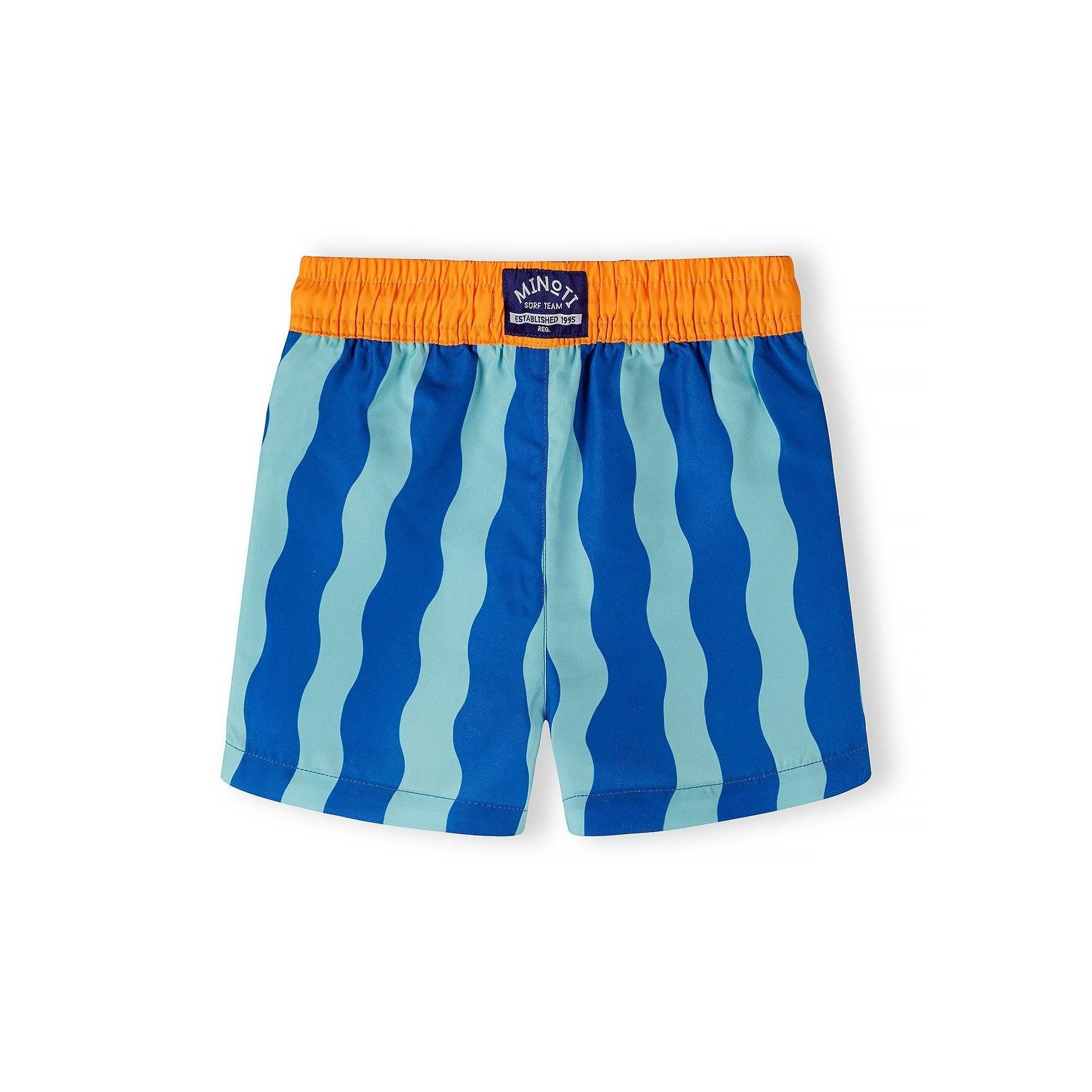 Close-up detail of swimming shorts waistband showing orange elasticated fabric with white drawstring and blue wavy stripe pattern below