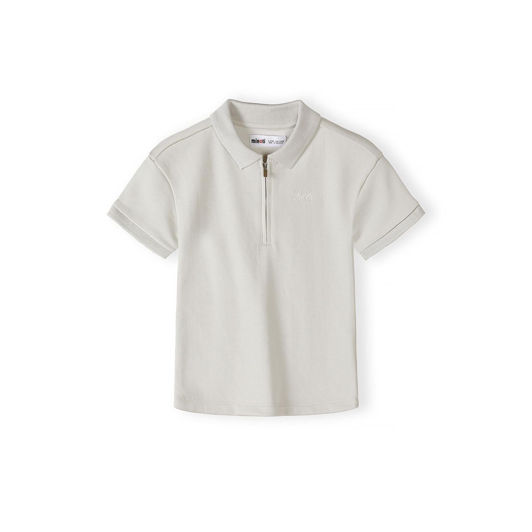 Close-up detail of grey pique polo shirt showing Minoti brand label, zip collar fastening and embroidered logo on textured fabric