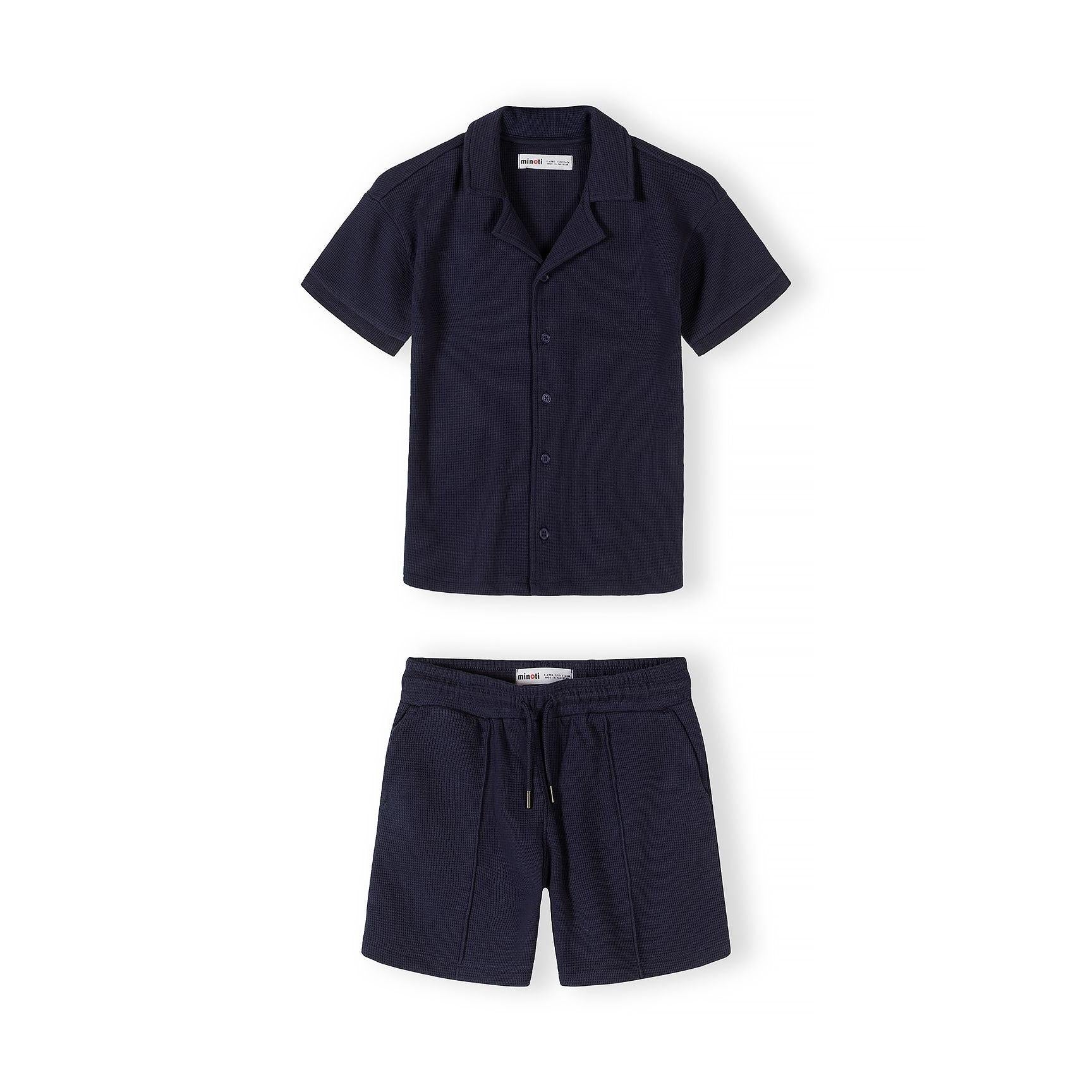 Back view of navy blue short sleeve polo shirt showing textured piqué cotton fabric and structured collar