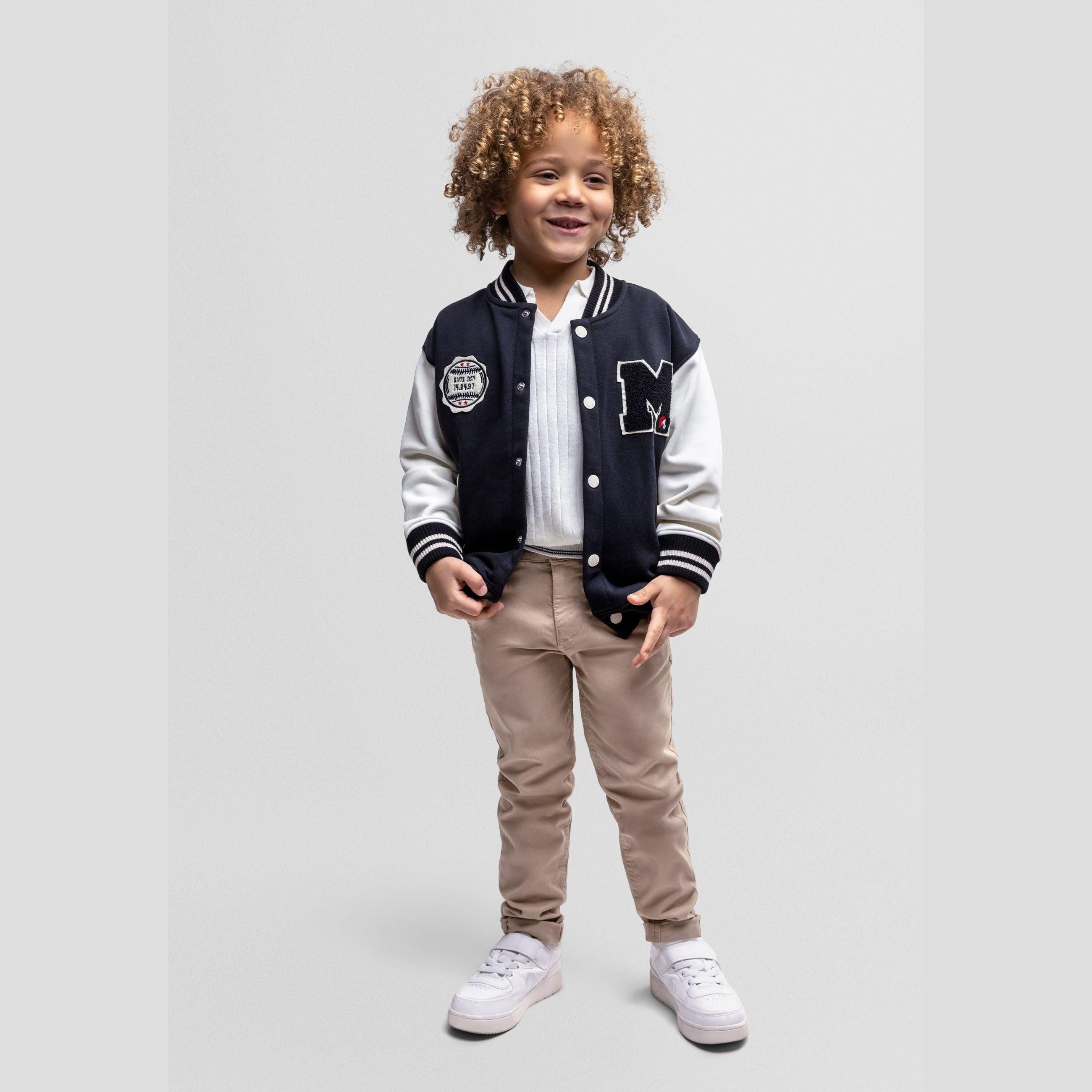 Black baseball jacket with white sleeves laid flat showing front view with M logo patch and button closure