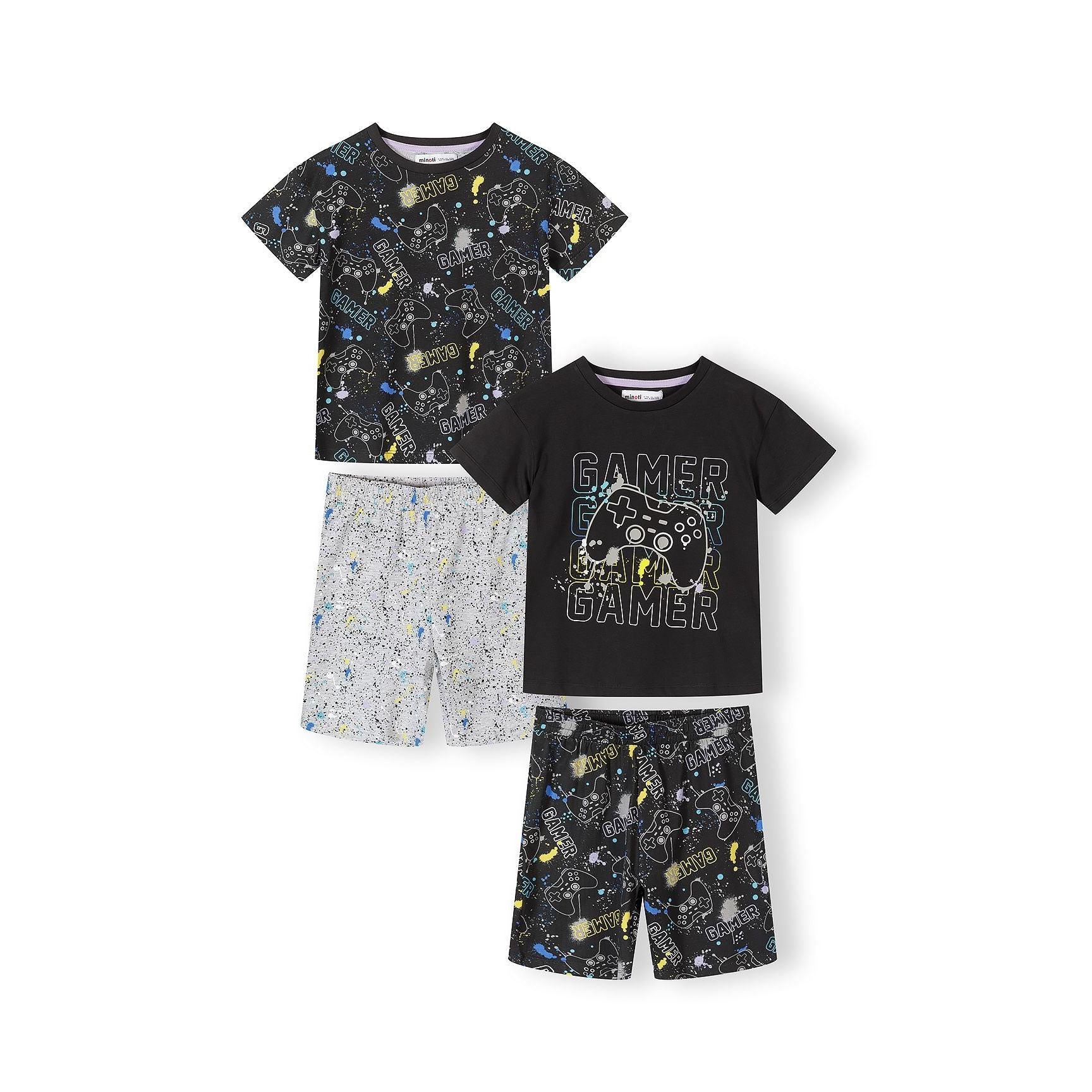 Gaming-themed pajama set laid flat showing two black printed t-shirts with gamer graphics and controller designs, plus grey splatter-print shorts and black gaming-print shorts on white background