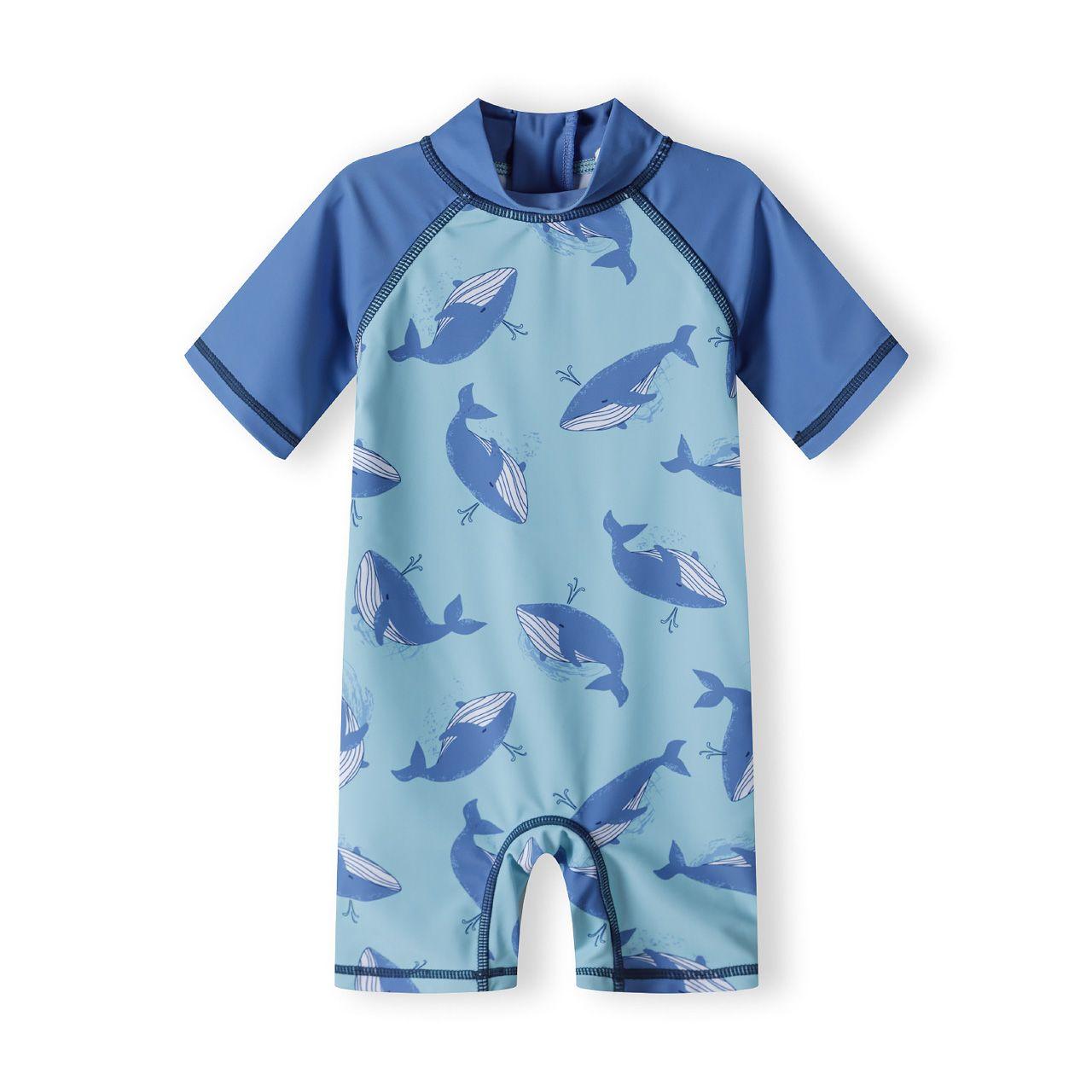 Back view of whale print sunsuit showing half zip closure and contrasting blue raglan sleeves on white background