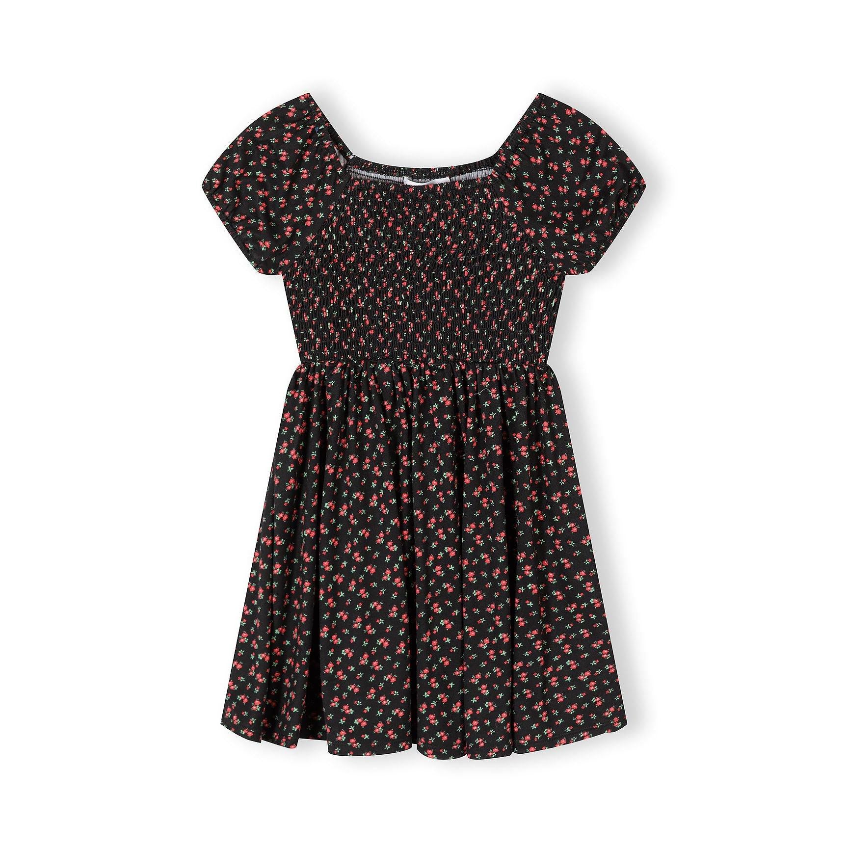 Black floral dress with short sleeves and shirred bodice featuring small red and pink flower print, displayed flat against white background