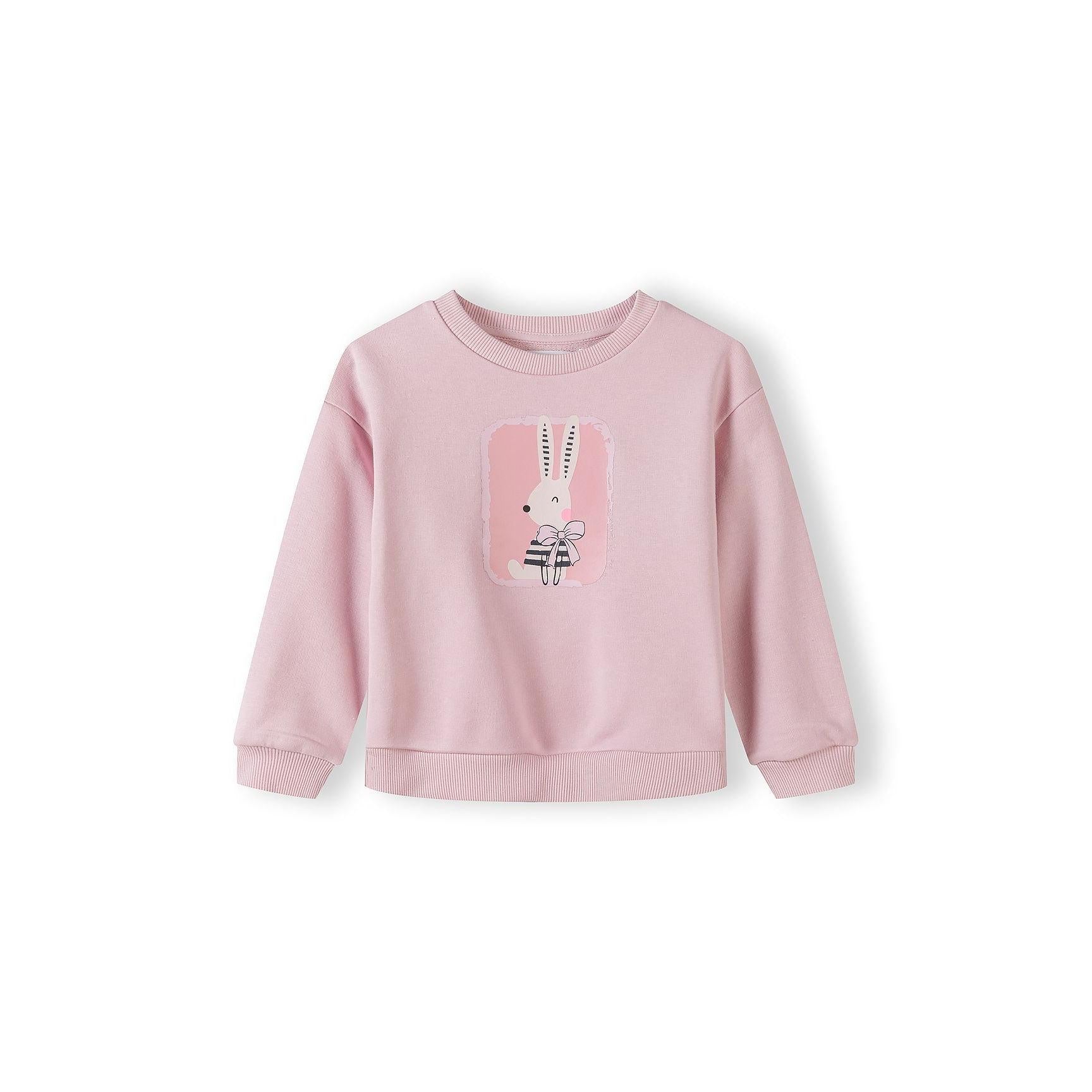 Beige girls sweatshirt with pink bow print pattern displayed flat on white background, showing ribbed cuffs and hem details
