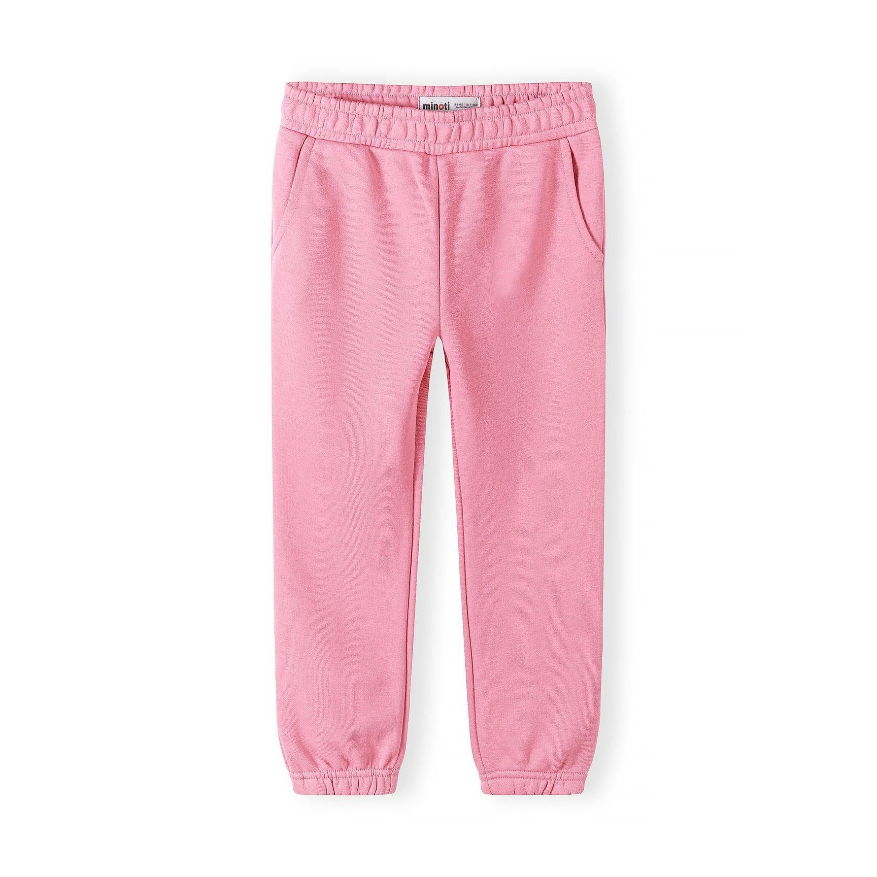 Single coral pink jogger laid flat showing elasticated waistband, side pockets and cuffed ankles on white background