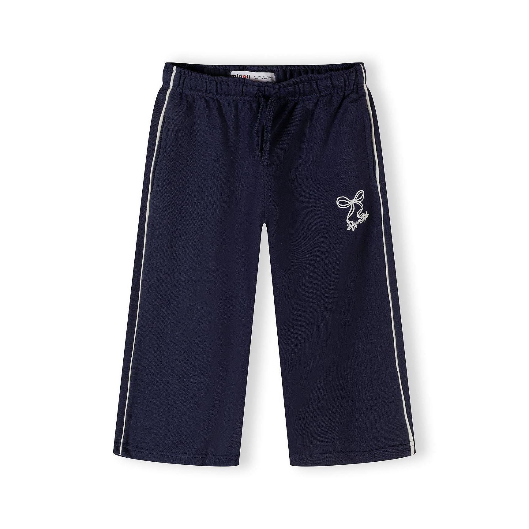 Close-up detail of navy tracksuit jacket showing Dance Studio logo embroidery, silver zip and front kangaroo pocket