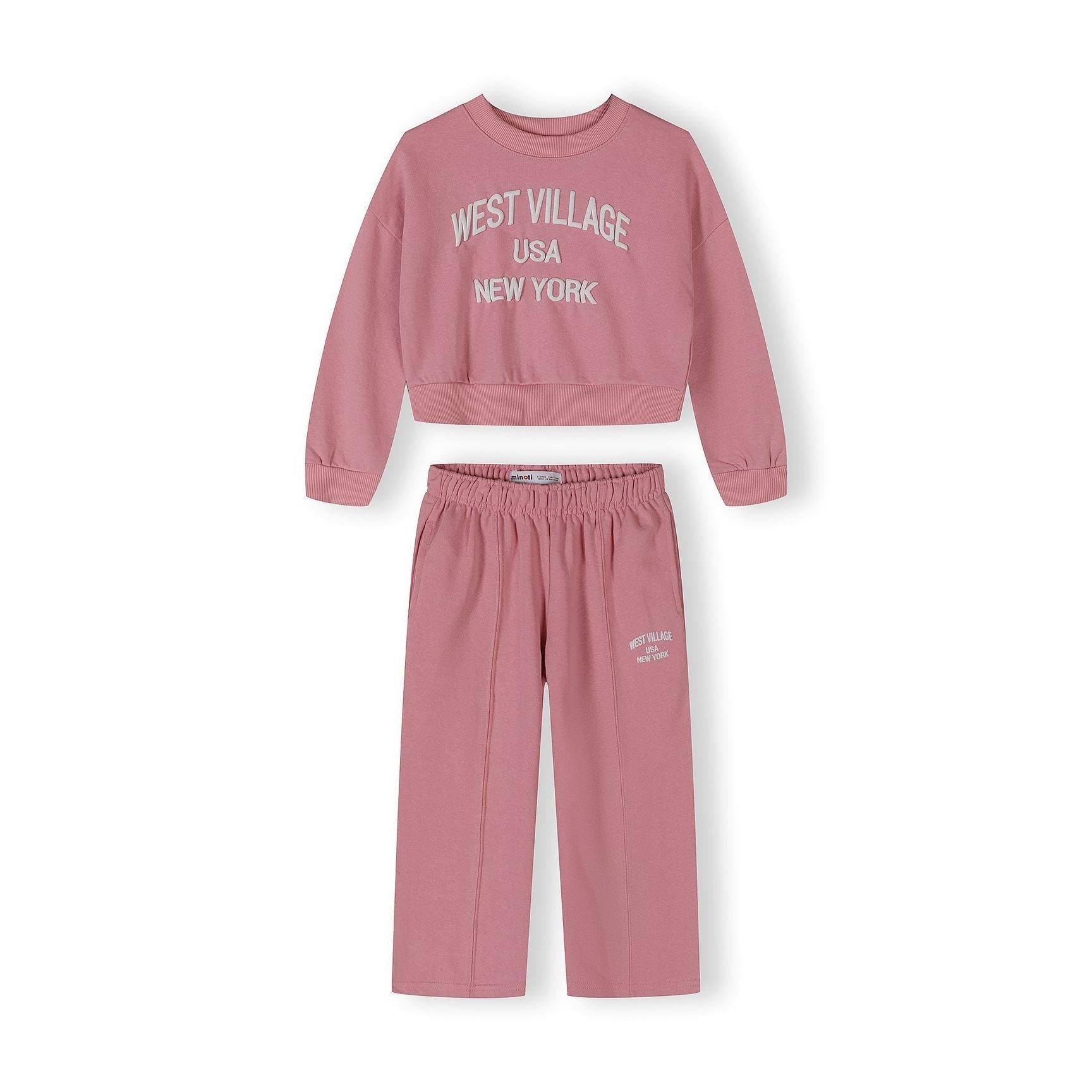 Pink tracksuit set with cropped sweatshirt and wide-leg joggers featuring West Village USA New York text, displayed on white background
