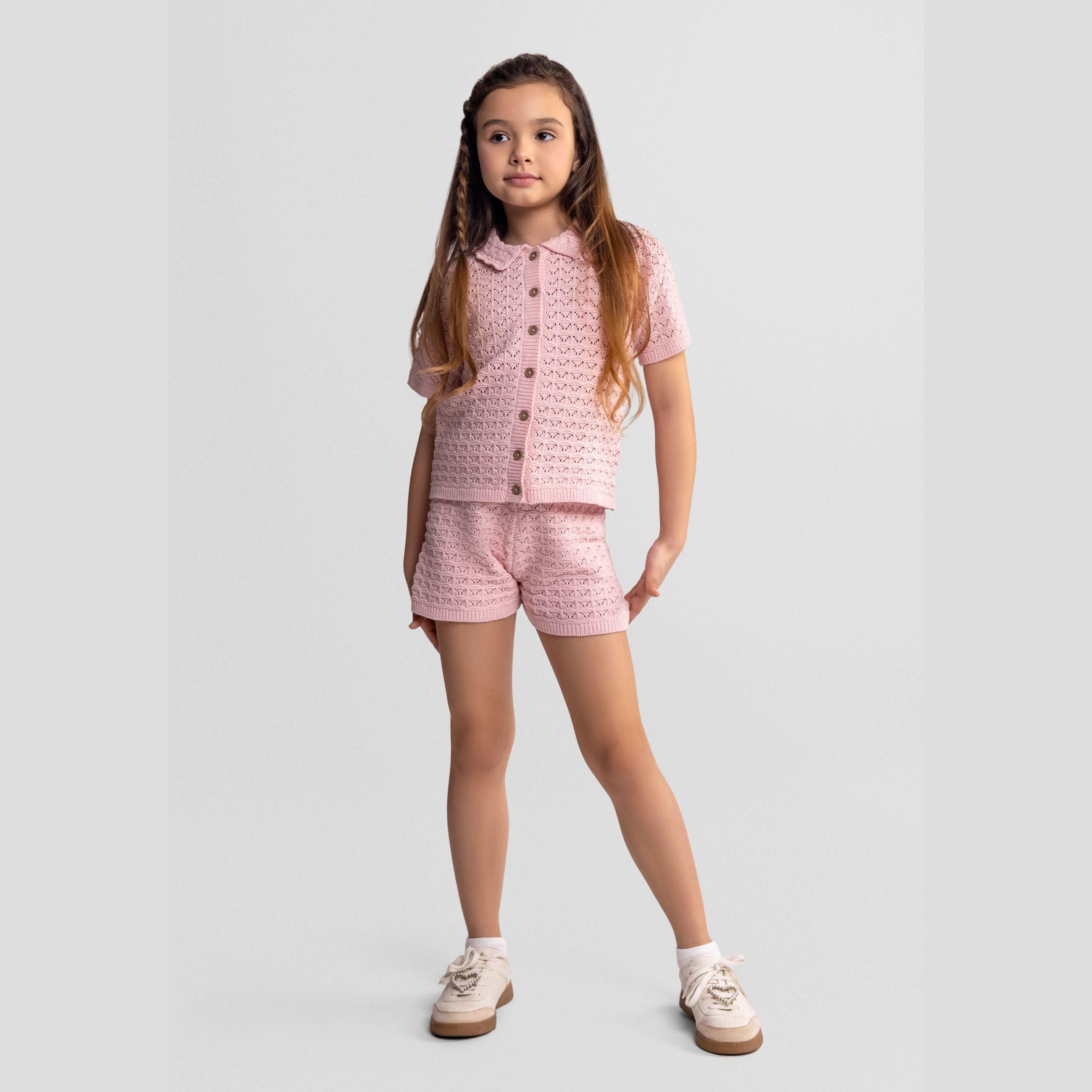 Blush pink pointelle knit cardigan with short sleeves displayed flat showing delicate openwork pattern and knitted texture